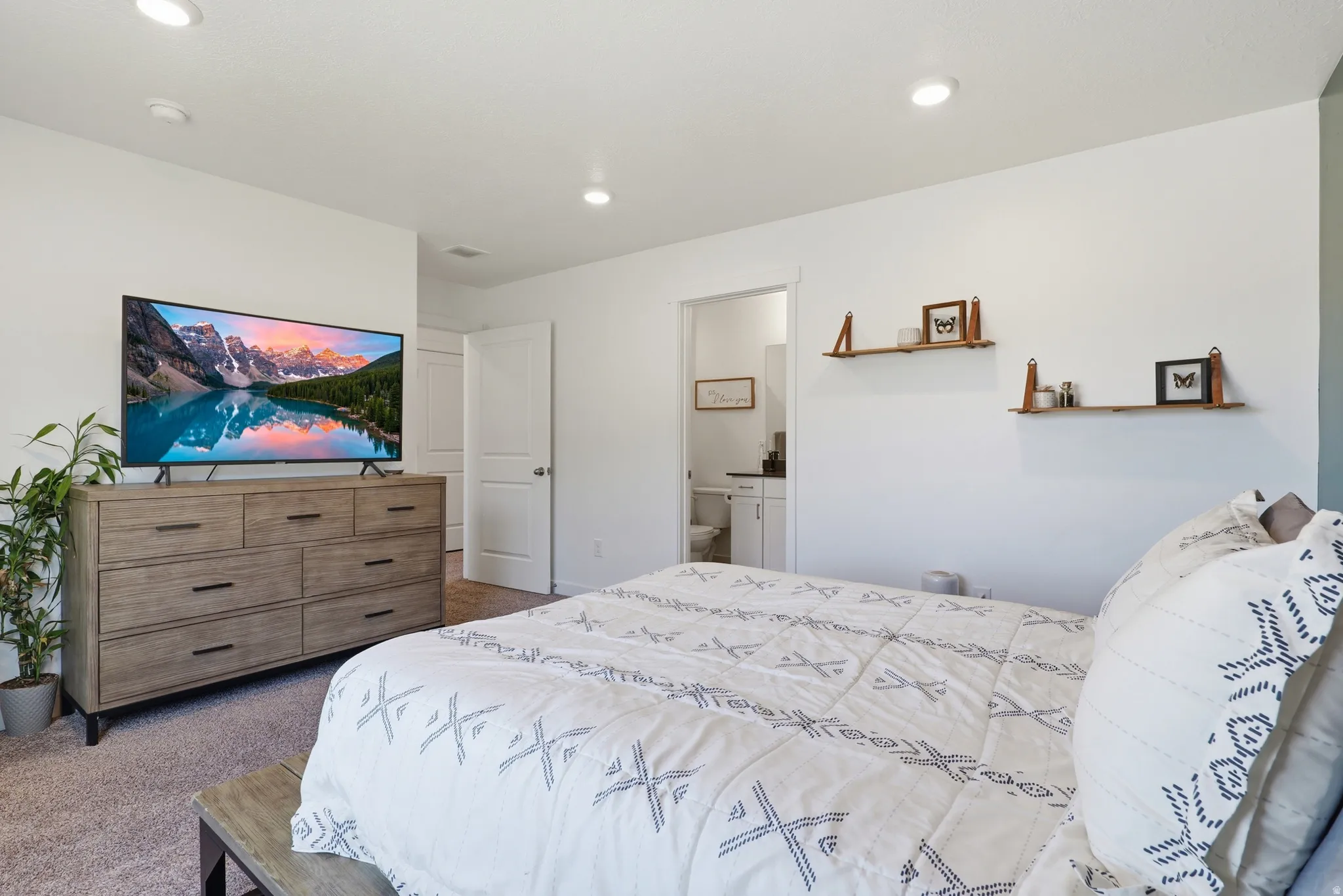 Spacious room featuring neutral carpeting, recessed lighting, and white walls