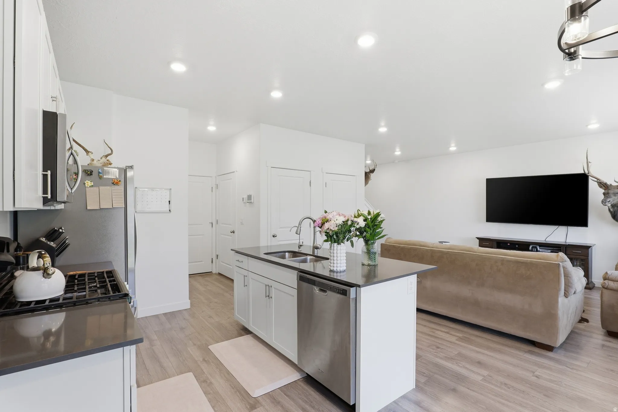 Kitchen and living area featuring wood-finish flooring
