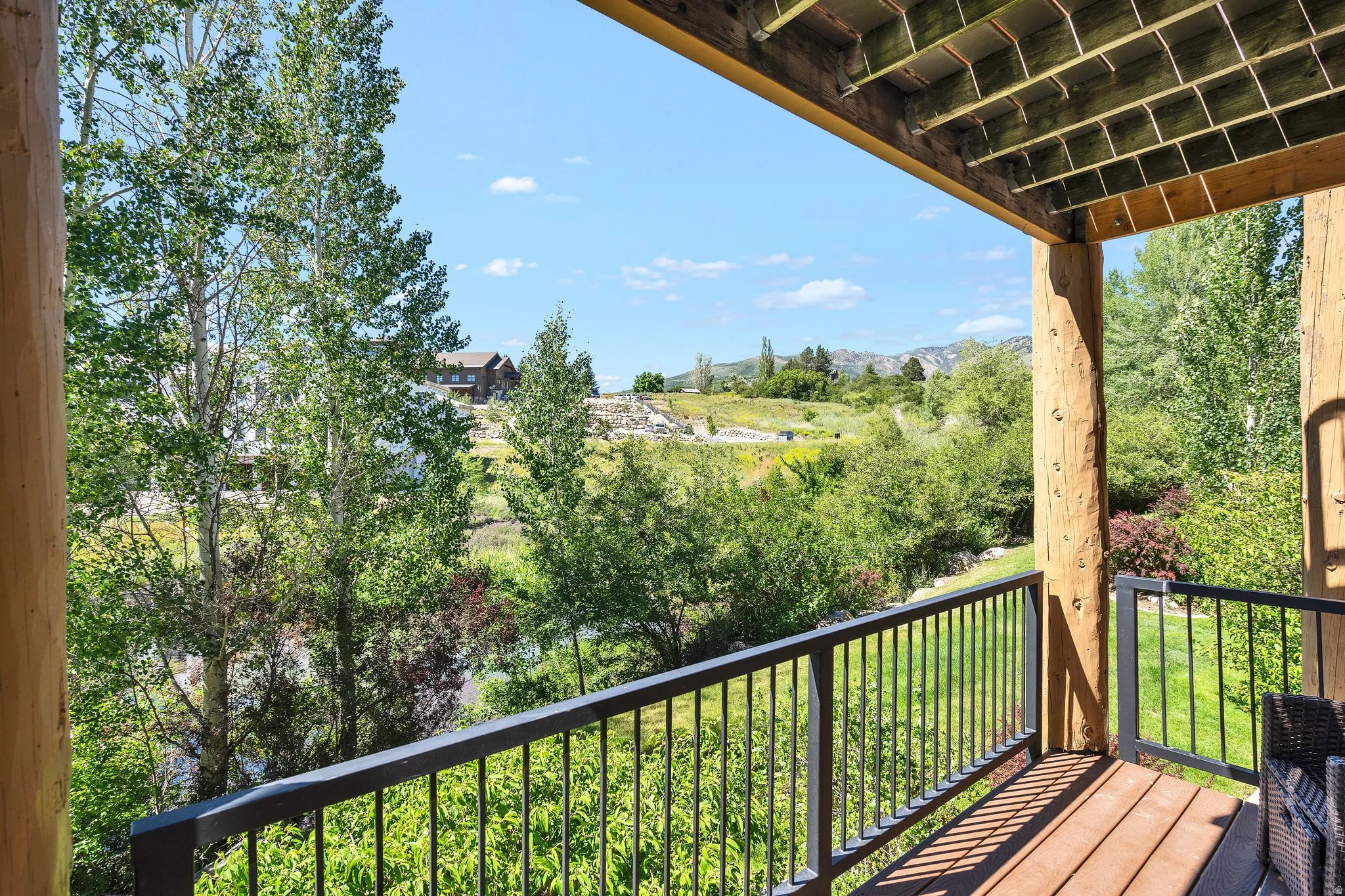 Outdoor deck featuring wood-finish flooring and sturdy log columns