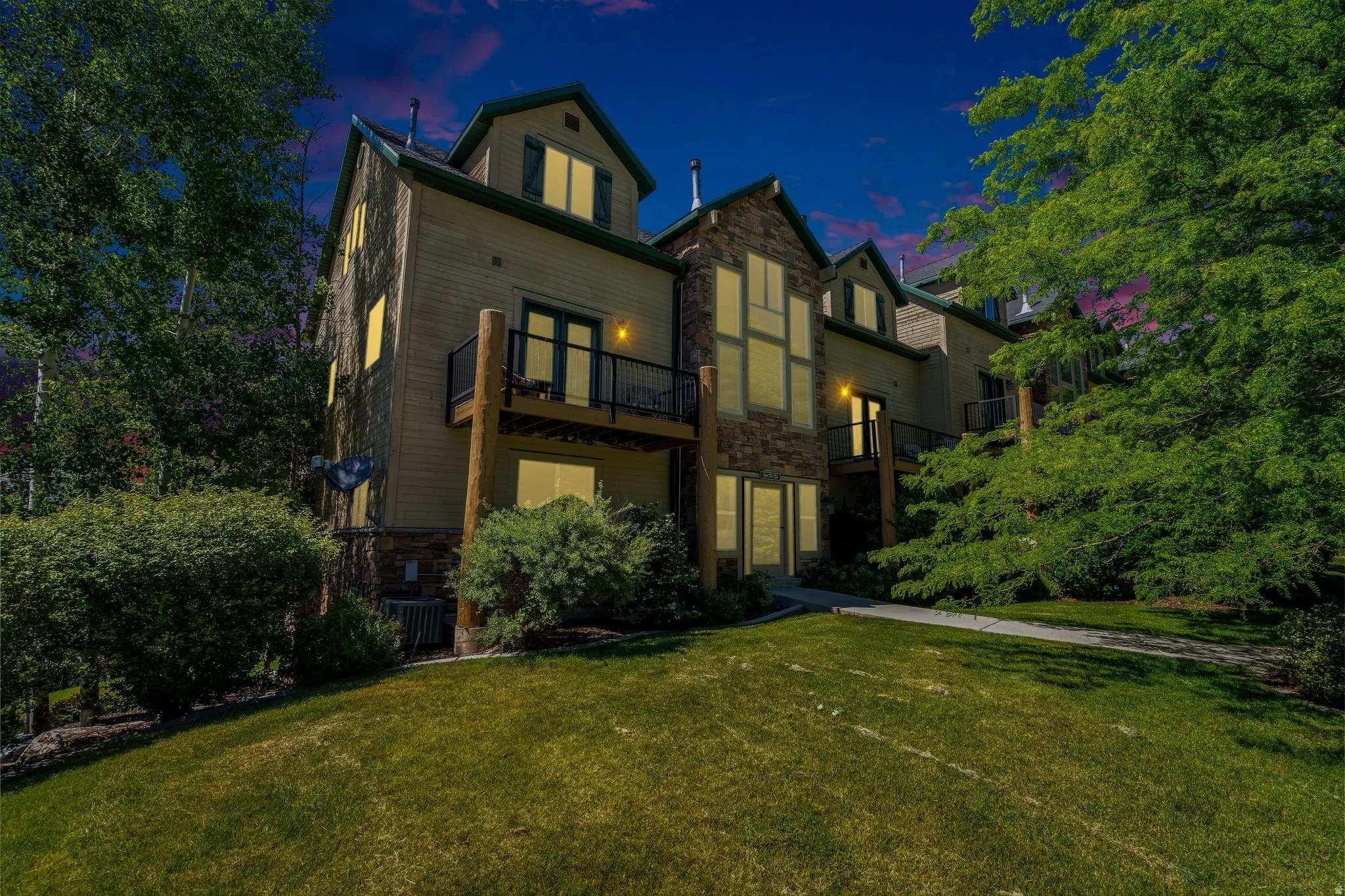 Multi-level property with a stone and siding exterior