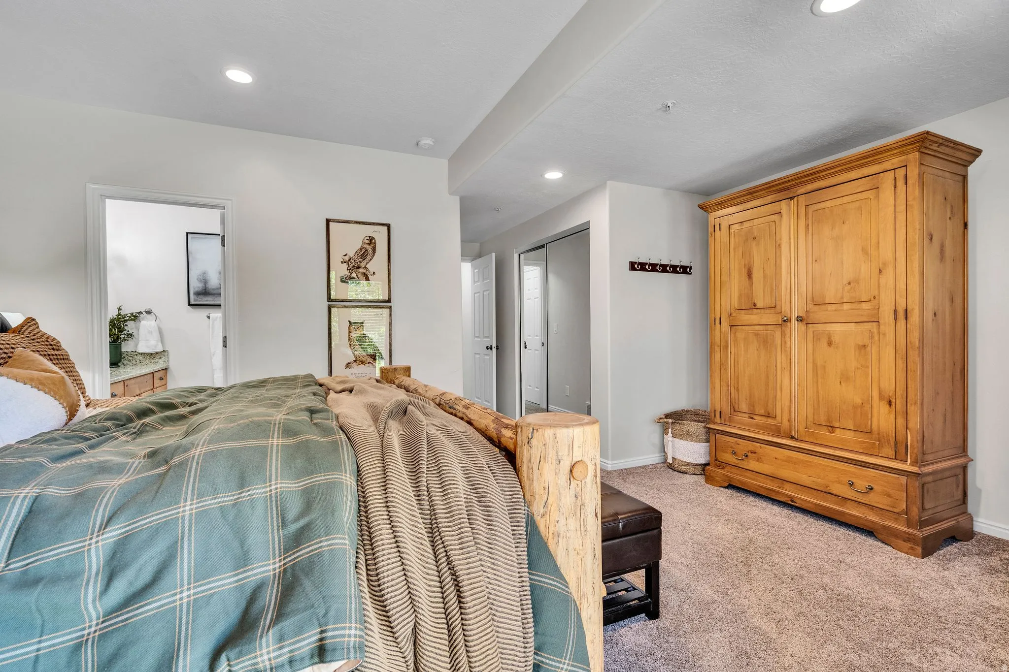 Plush carpet flooring complements recessed lighting and a built-in closet with mirrored sliding doors