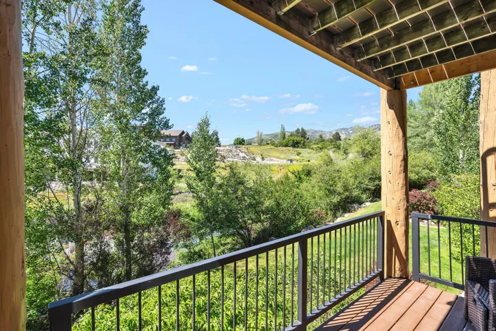 Outdoor deck featuring wood-finish flooring and sturdy log columns
