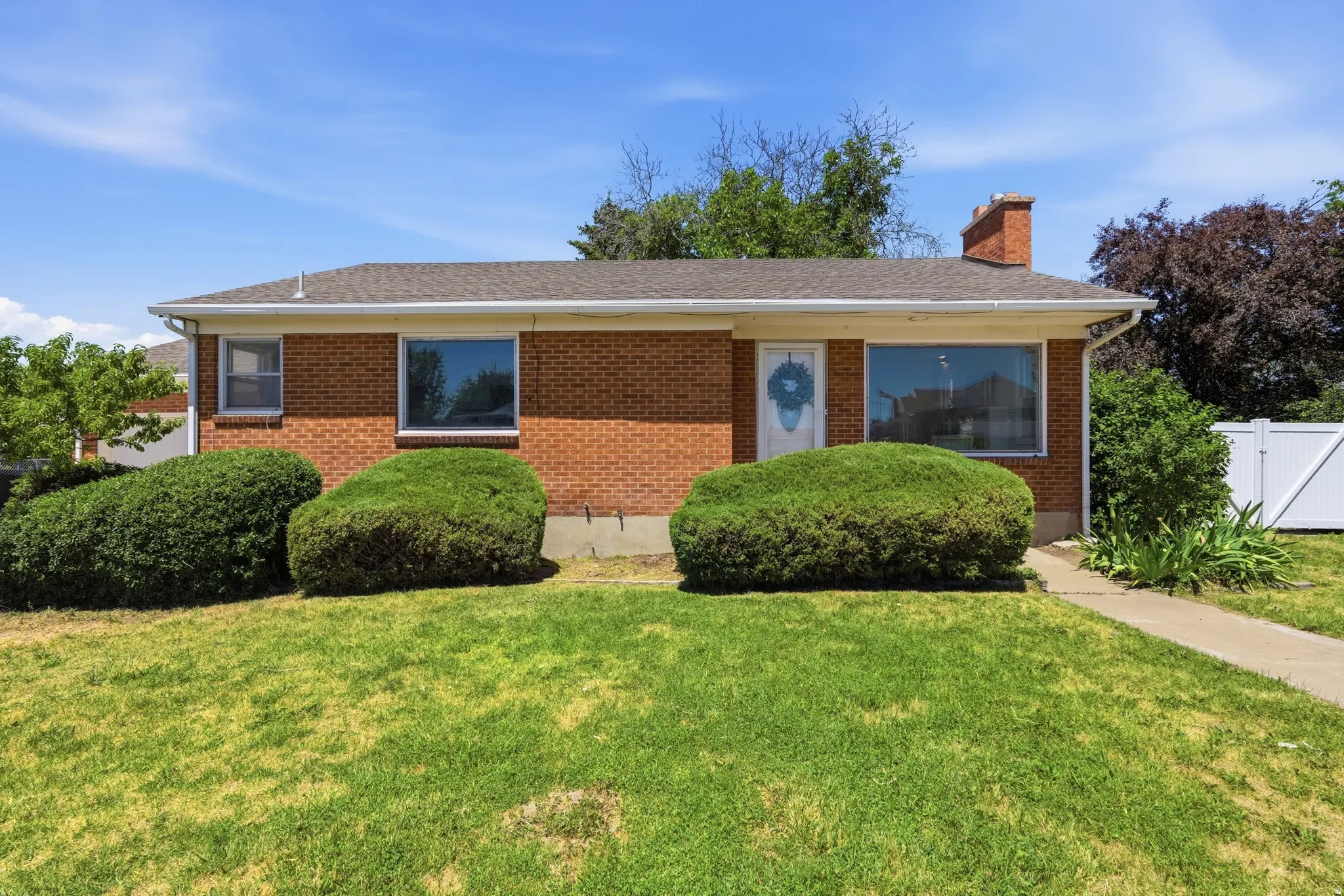 Brick exterior with a gabled roof and white trim