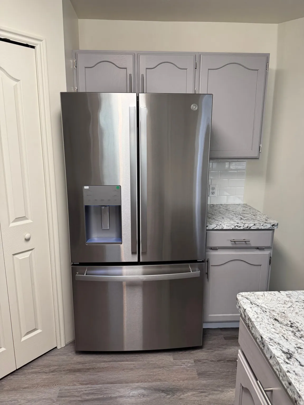 Stainless steel refrigerator with a French door design and bottom freezer drawer
