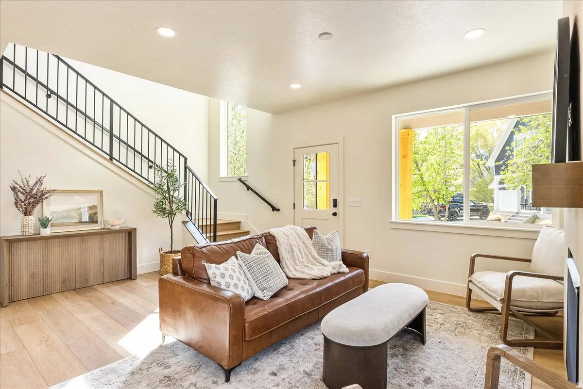 Open-concept living area with light wood-finish flooring
