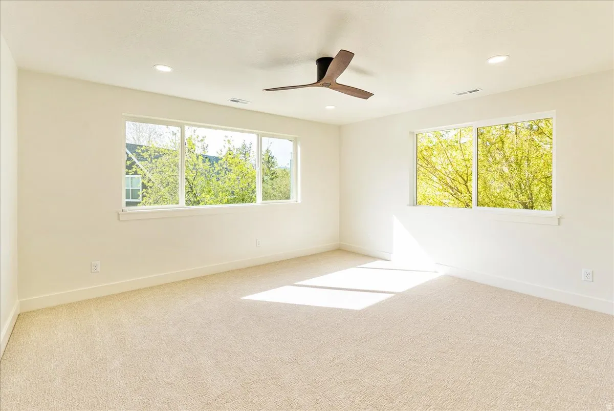 Bright interior space with light-toned carpeting and white walls