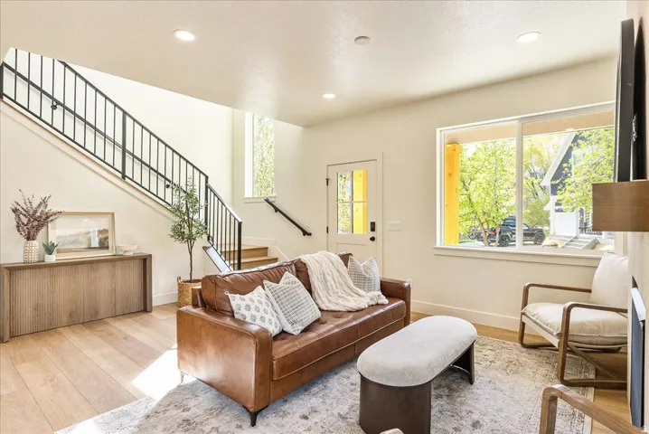 Open-concept living area with light wood-finish flooring