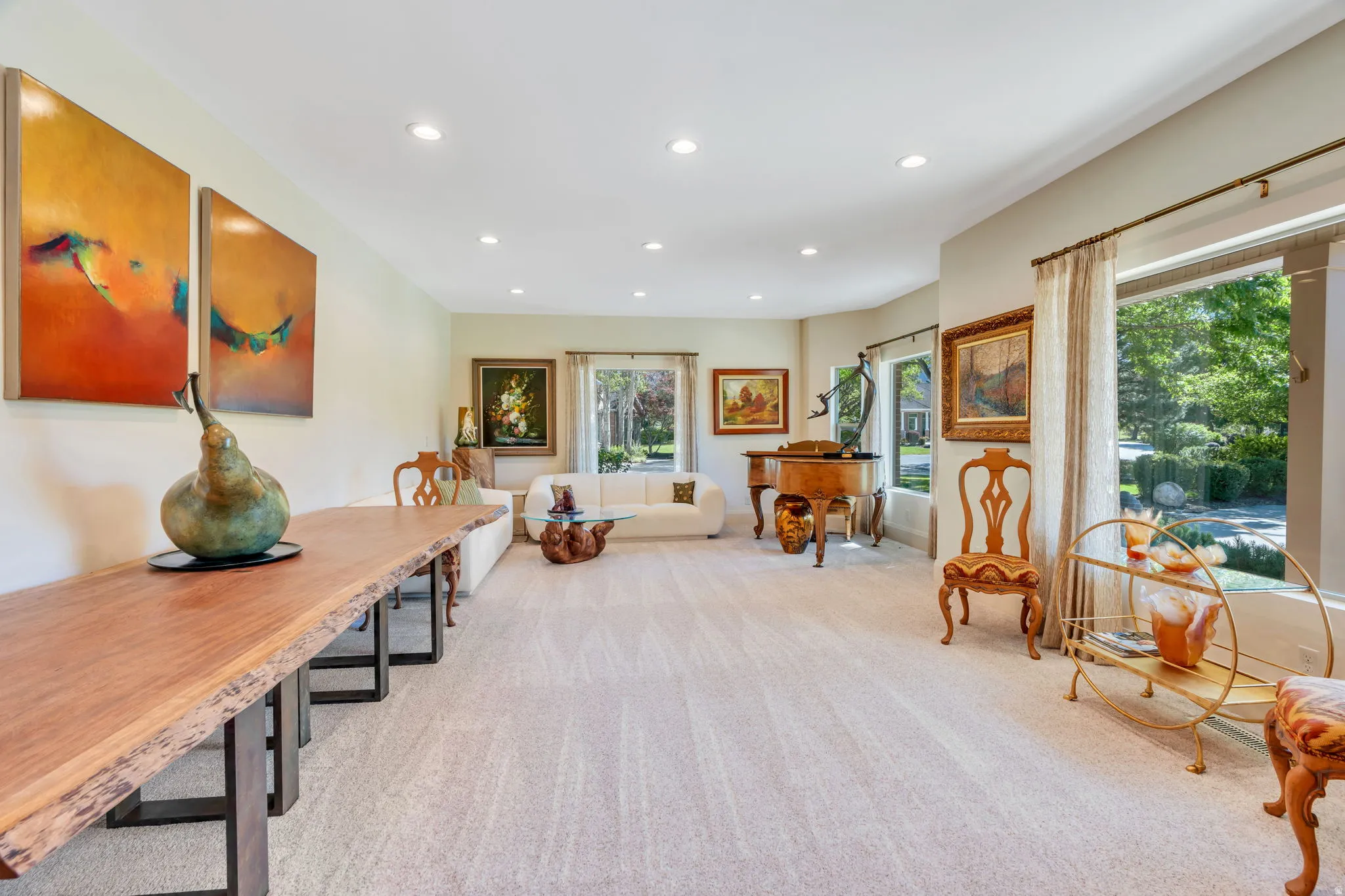 Spacious interior room featuring light-toned carpeting and recessed lighting