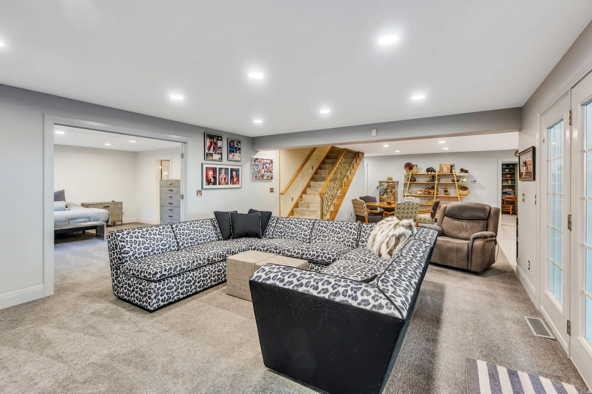 Spacious finished lower level with recessed lighting, light gray carpeting, and white trim