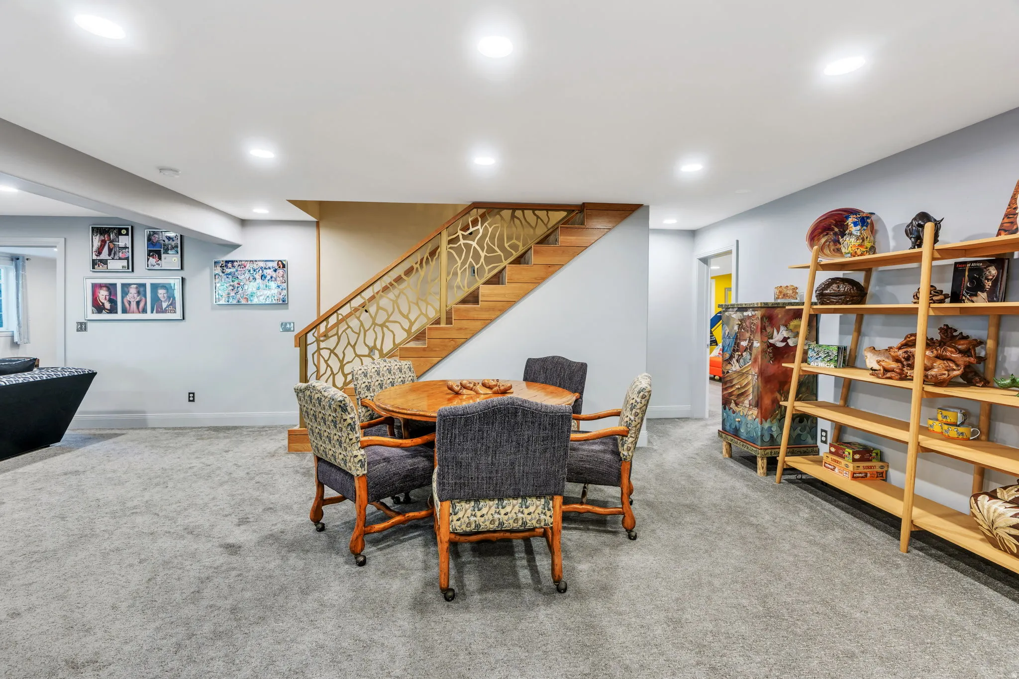 Spacious lower-level area featuring light gray wall paint and recessed lighting