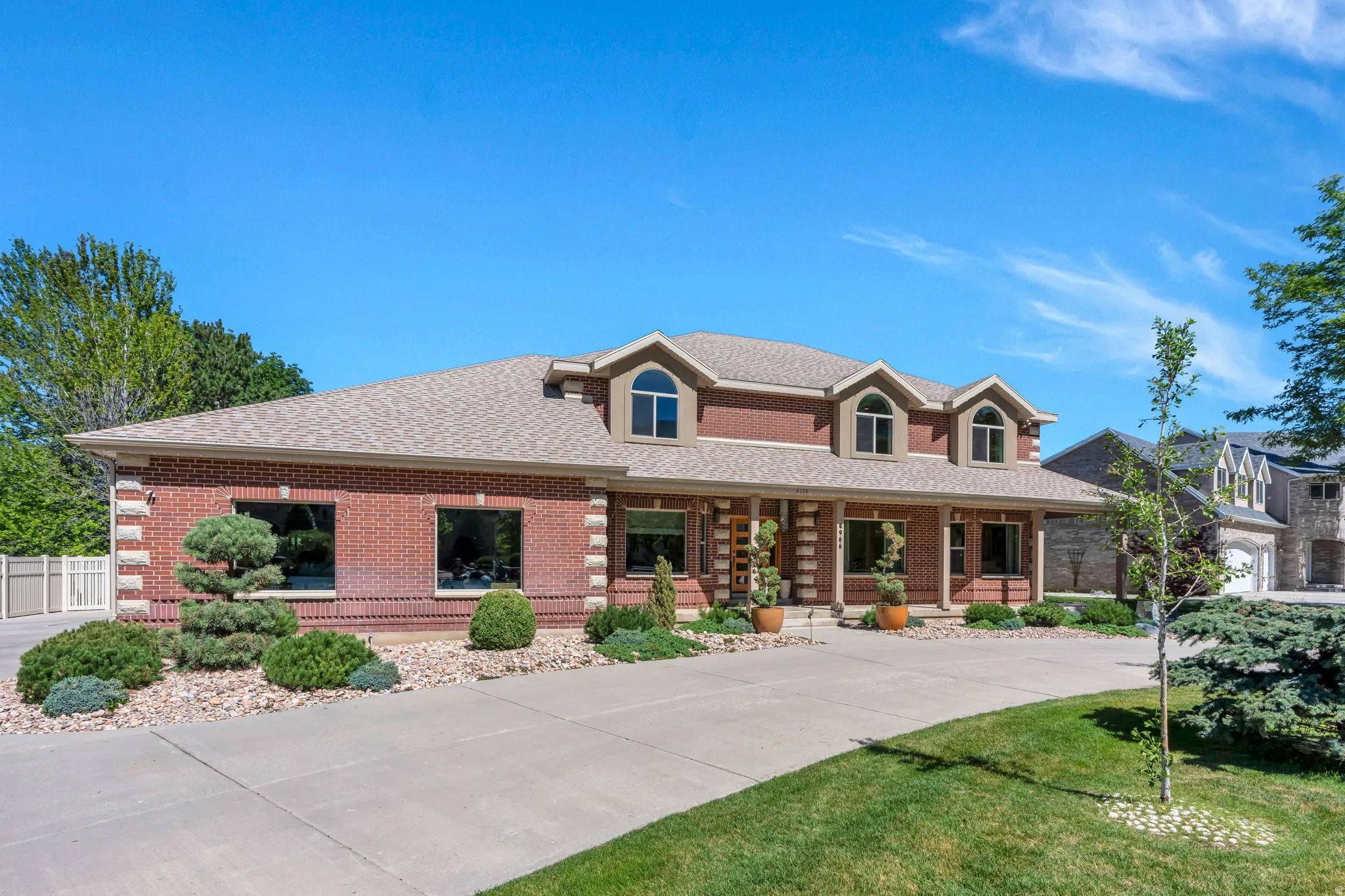 Brick exterior with stone accents and a neutral-toned roof