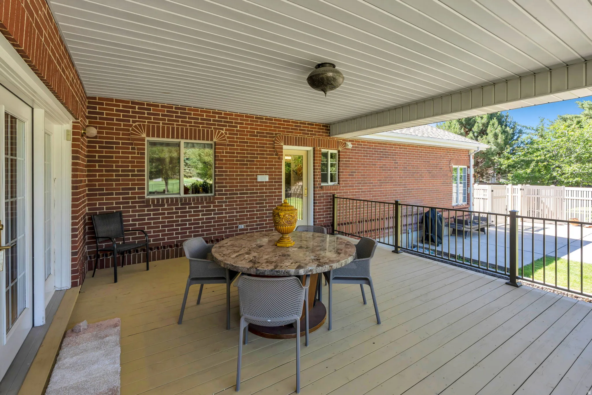 Covered outdoor deck with light-toned flooring