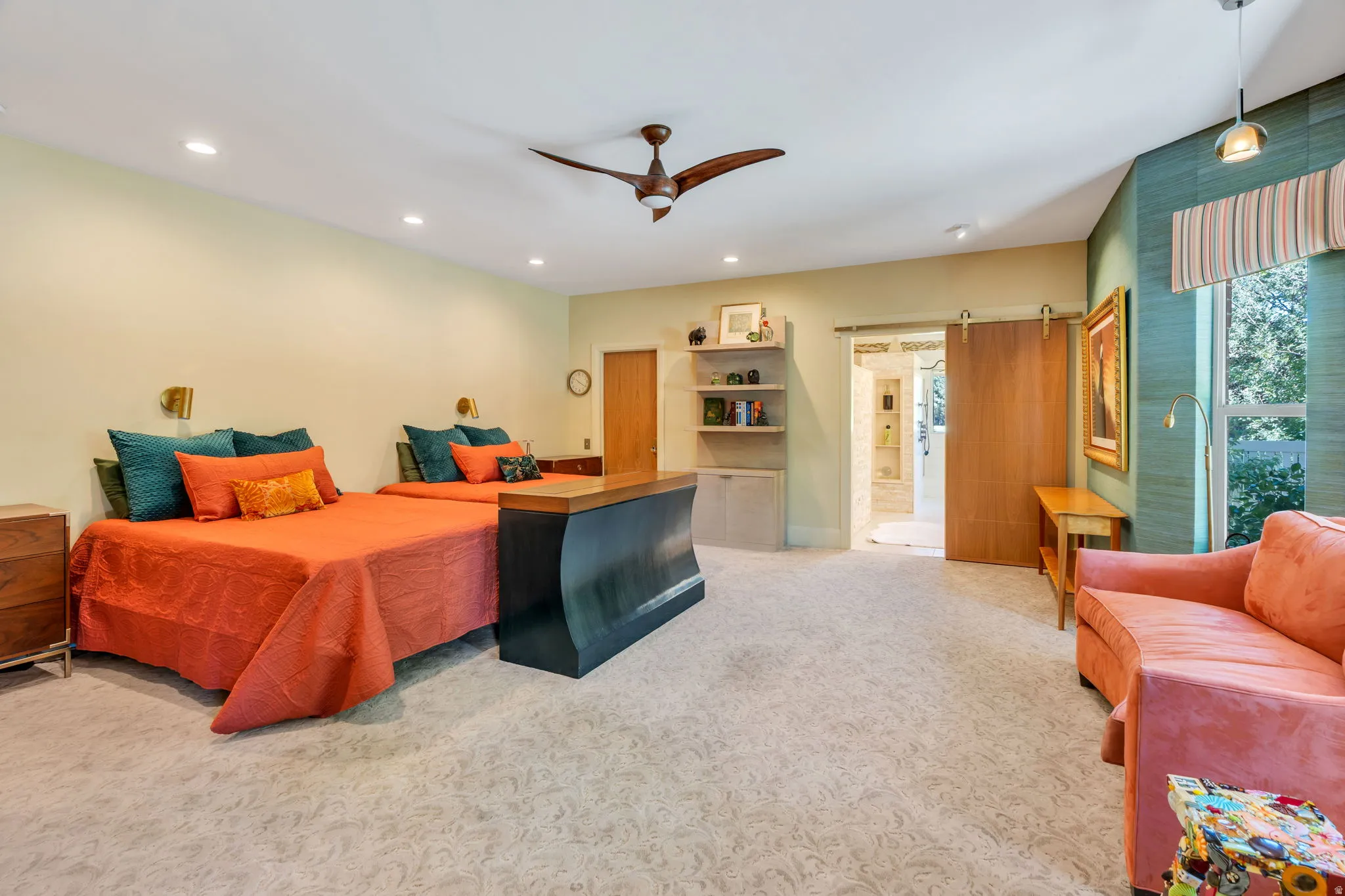 Spacious room featuring patterned carpeting, recessed lighting, and a ceiling fan