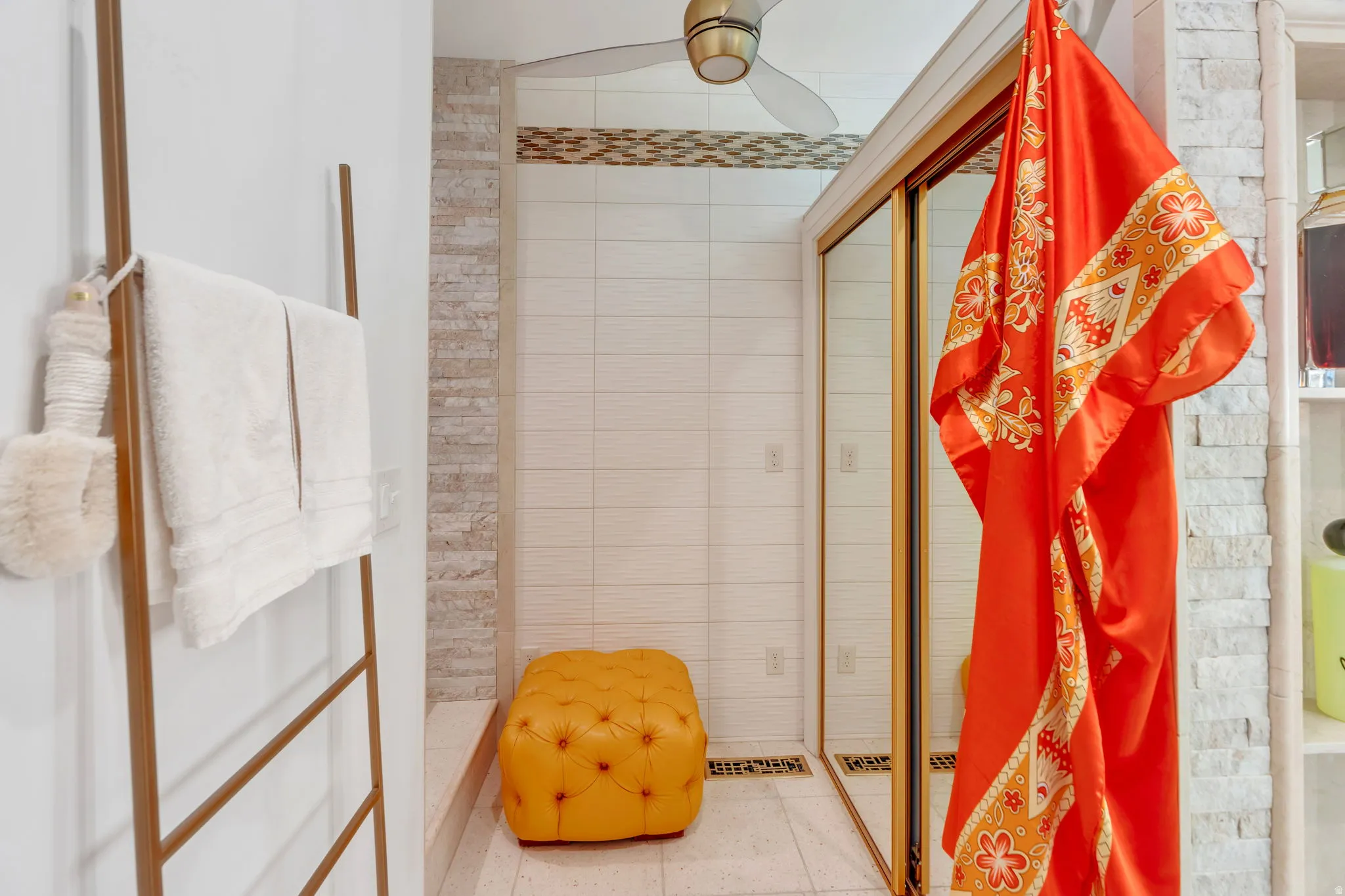 Shower enclosure with gold-toned framing and sliding glass doors