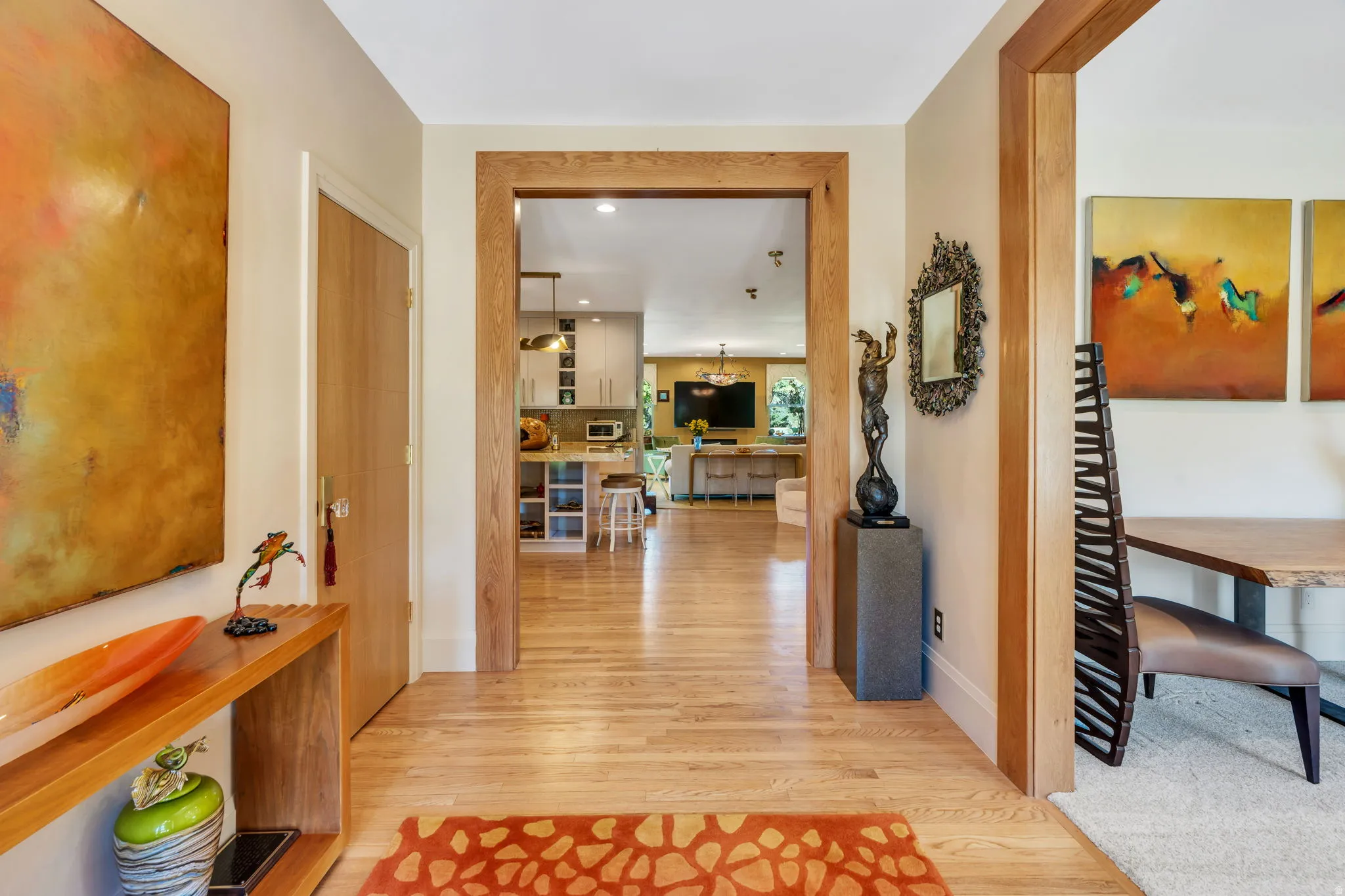 Hardwood flooring extends throughout the hallway, framed by light wood trim
