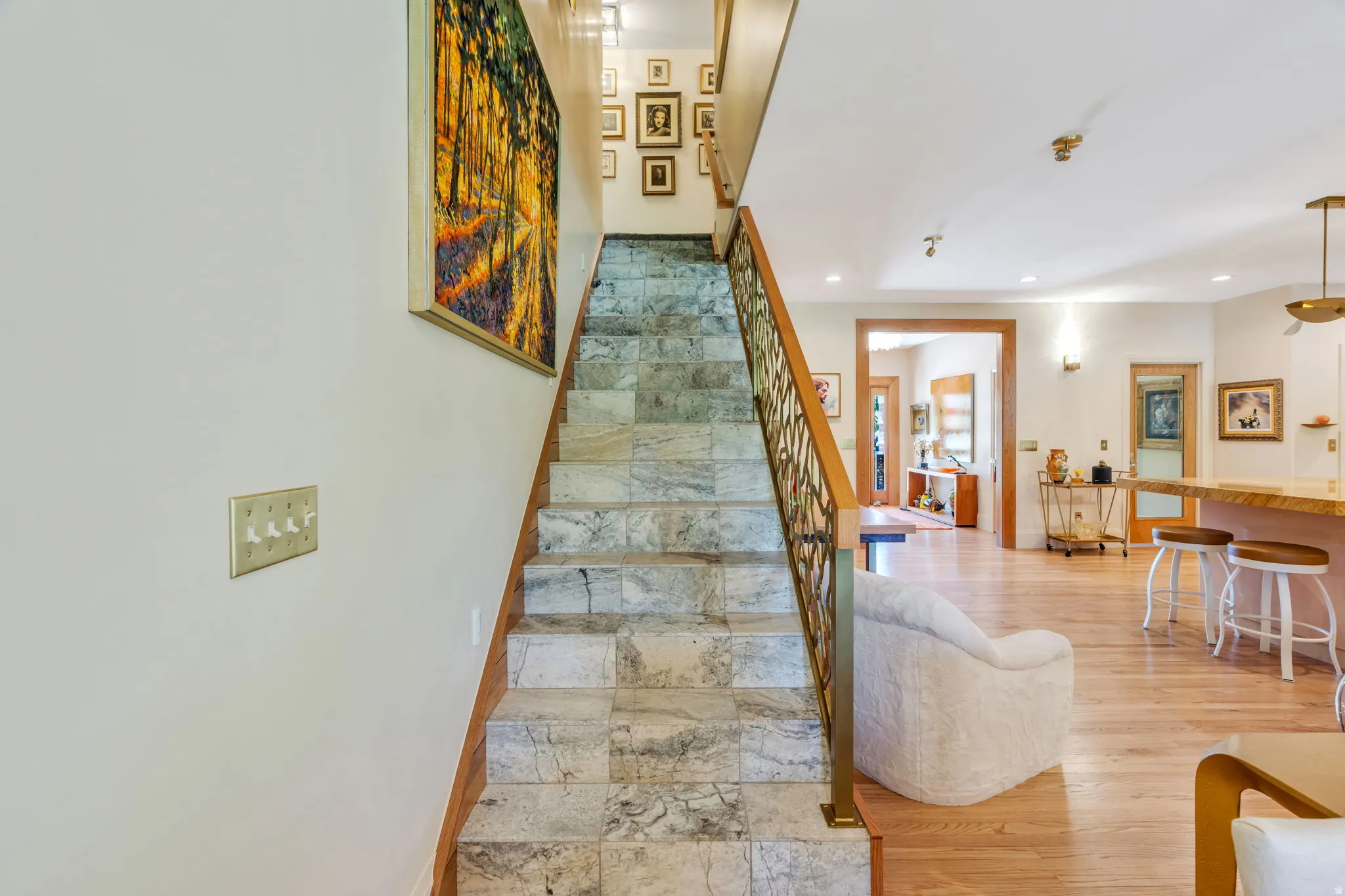 Staircase with tile treads and a decorative metal railing