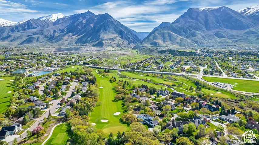 Residence backs the golf course with lush green landscapes, and a prominent mountainous backdrop
