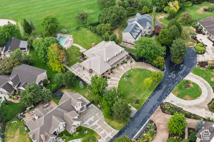 Expansive property featuring an in-ground swimming pool, established trees, and surrounding green spaces