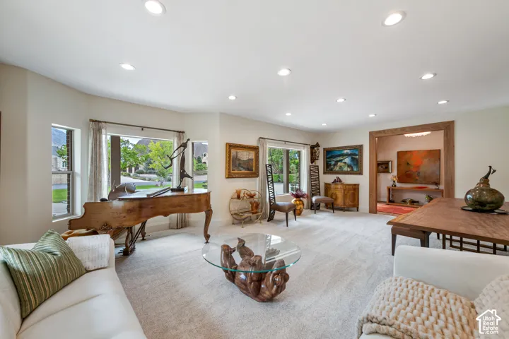 Spacious living area featuring recessed lighting, a wide archway, and expansive windows