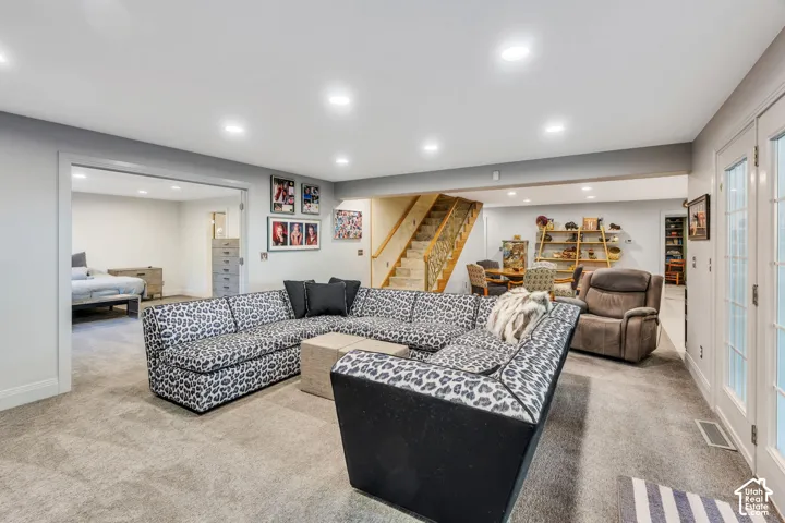 Spacious finished lower level with recessed lighting, light gray carpeting, and white trim