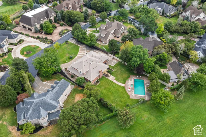 Expansive exterior featuring a swimming pool, surrounding patio, and fenced yard