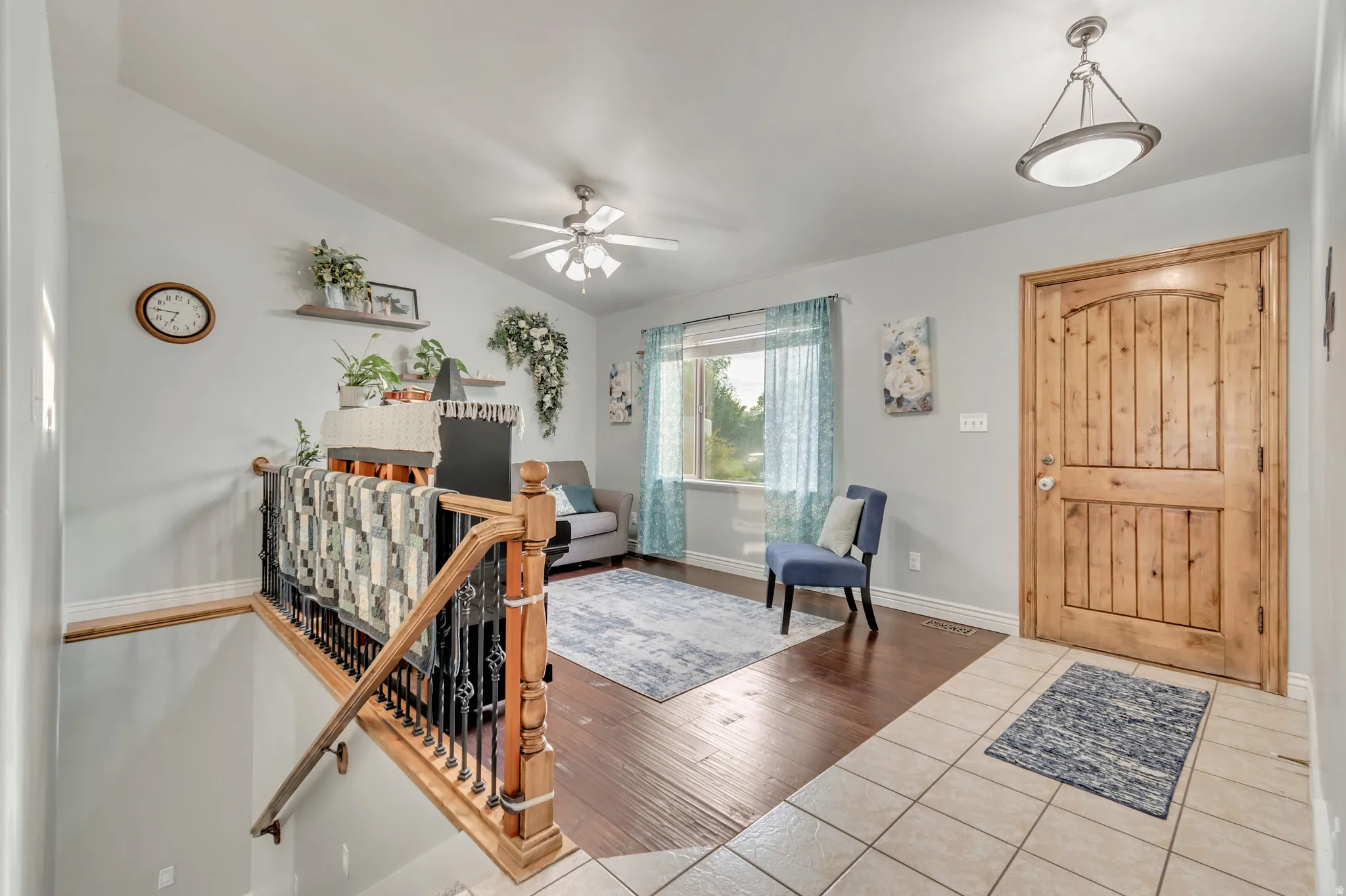 Entryway featuring a solid wood panel door, tiled flooring, and a contemporary ceiling light fixture