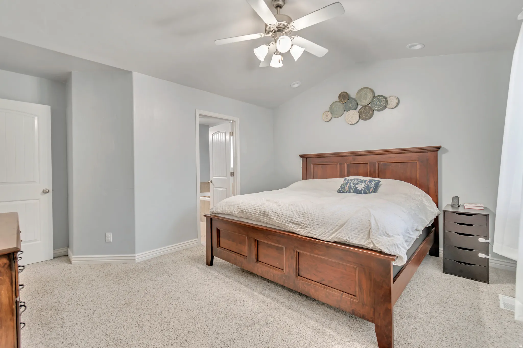 Carpeted room featuring a ceiling fan with light fixture, recessed lighting, and white baseboards