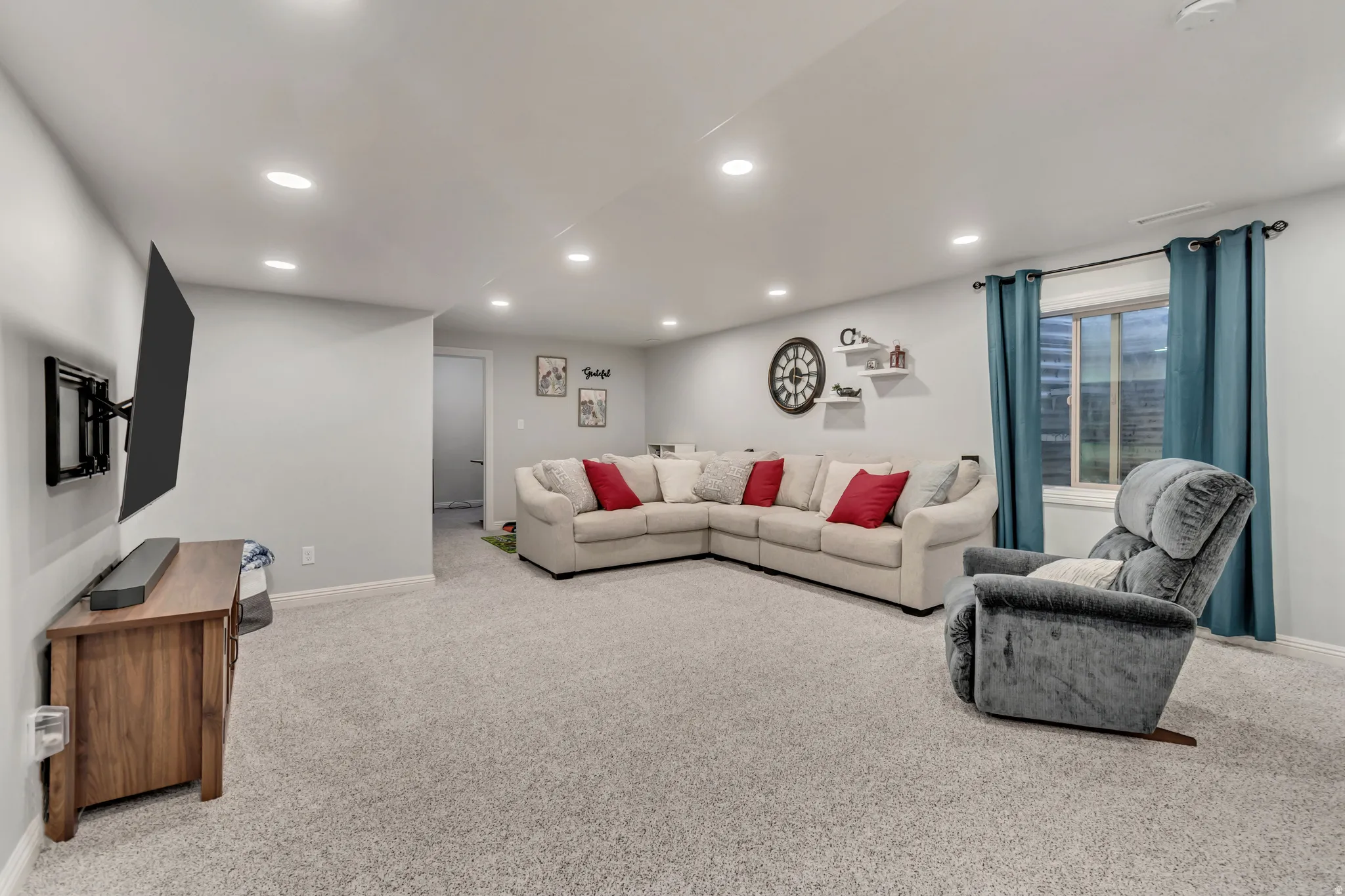 Spacious interior featuring light gray wall paint and recessed ceiling lighting