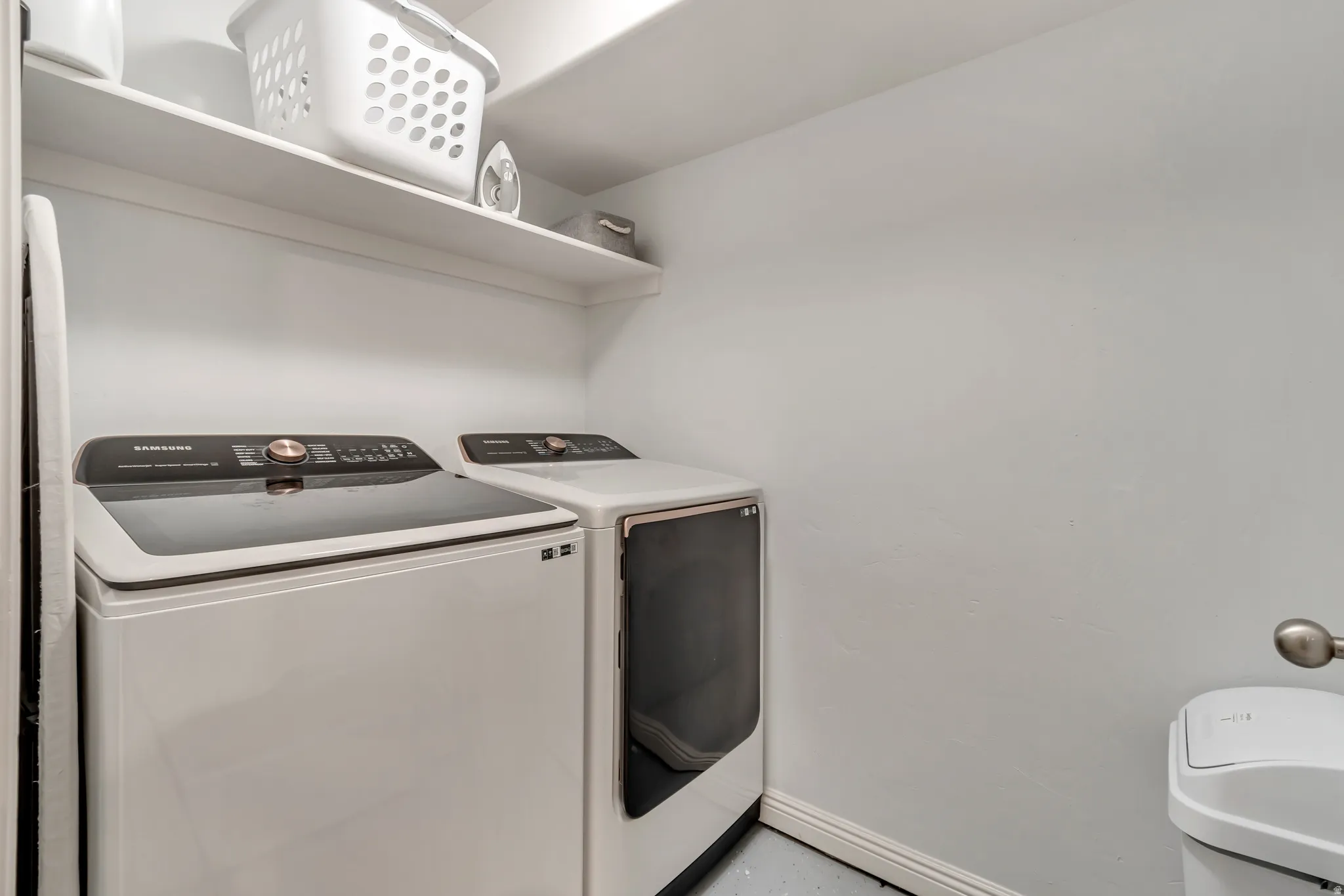 Dedicated laundry area featuring a white top-load washer and front-load dryer