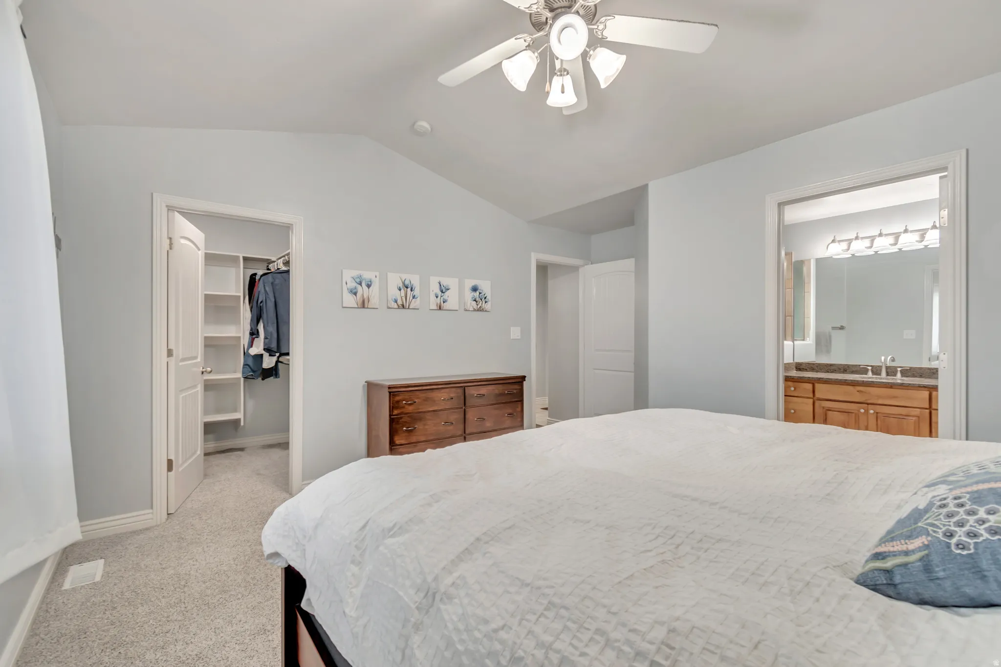 Interior room featuring light gray wall paint, a ceiling fan with integrated lighting, and carpet flooring