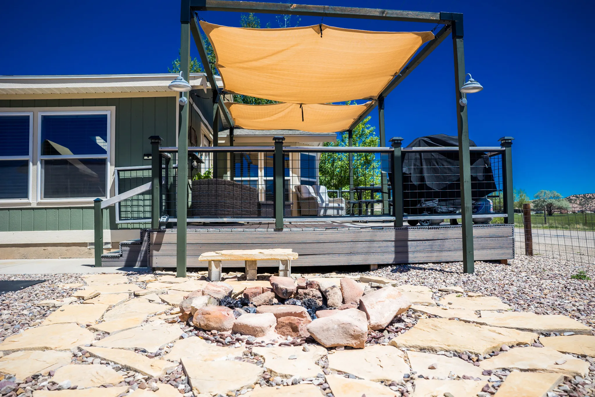 Flagstone patio featuring a stone-lined fire pit