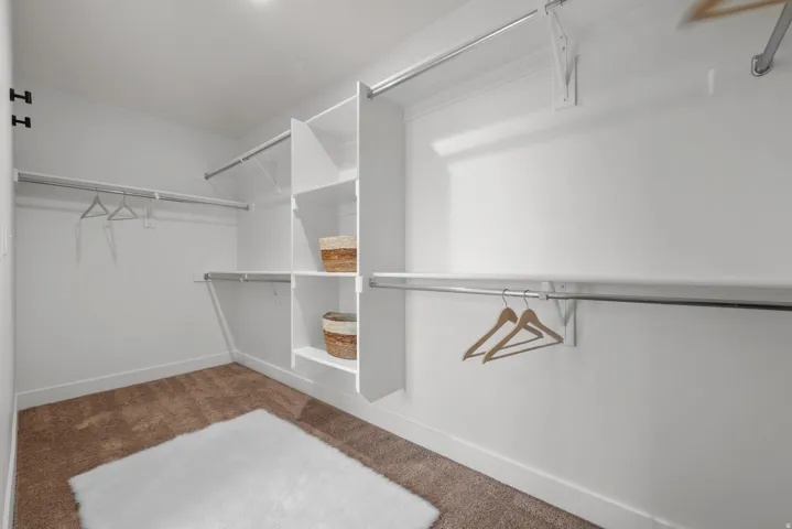 Walk-in Primary closet with built-in shelving,
