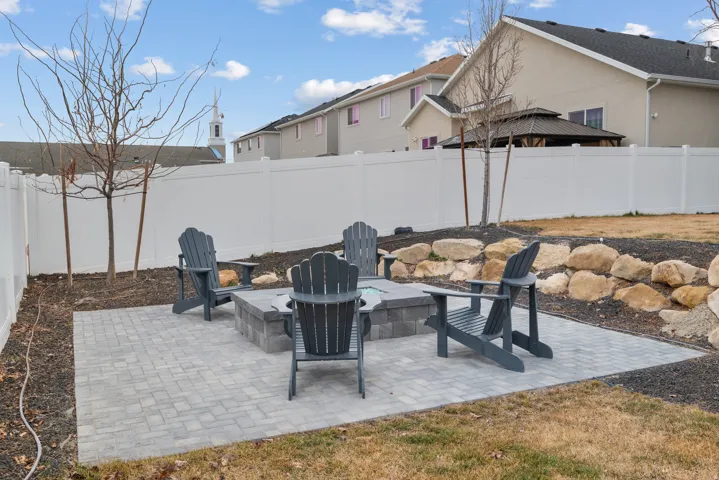 finished backyard with paver patio and fire pit