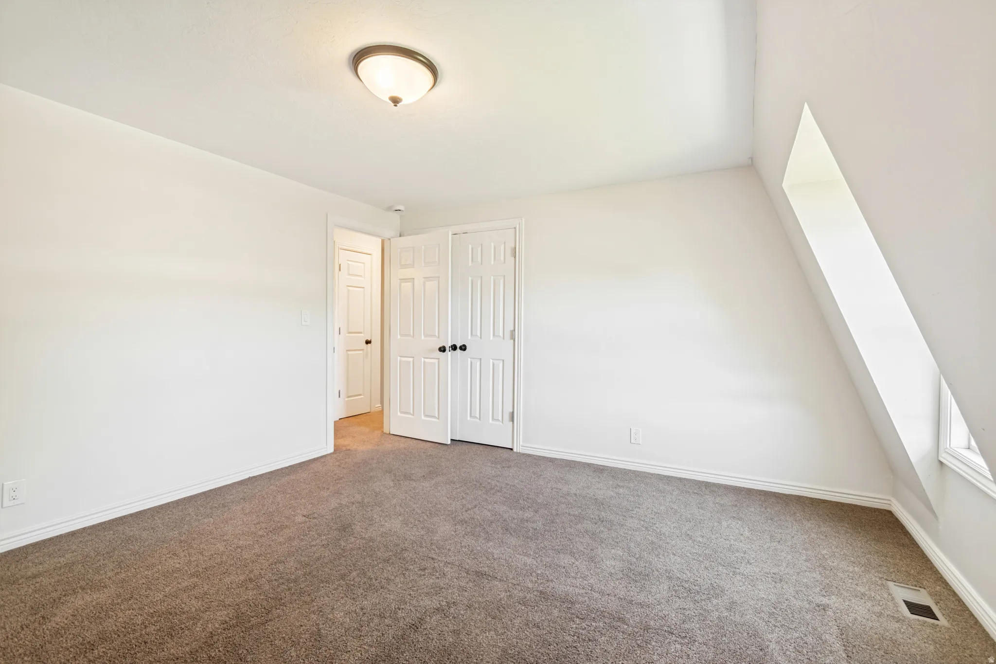 Neutral-toned carpeting paired with white walls