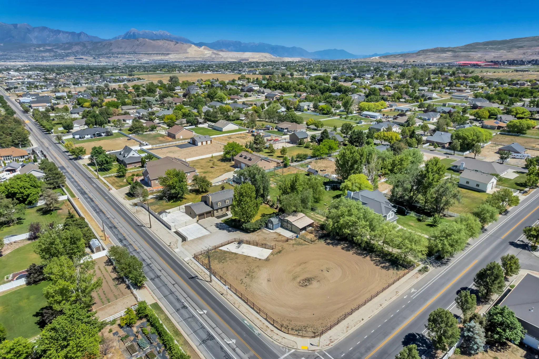 Expansive corner lot with mountain backdrop, surrounded by established residential properties