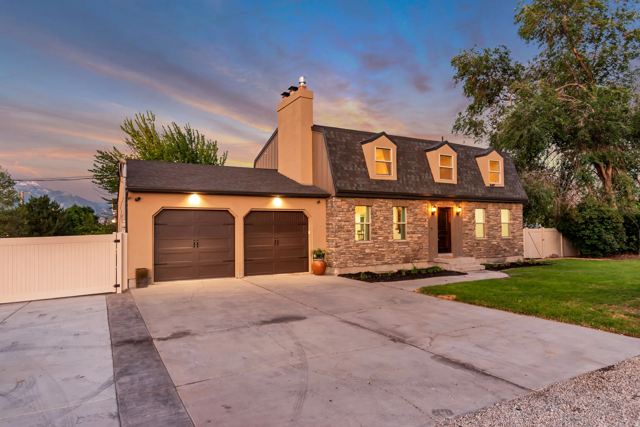 Architectural stone and stucco exterior with dormer windows