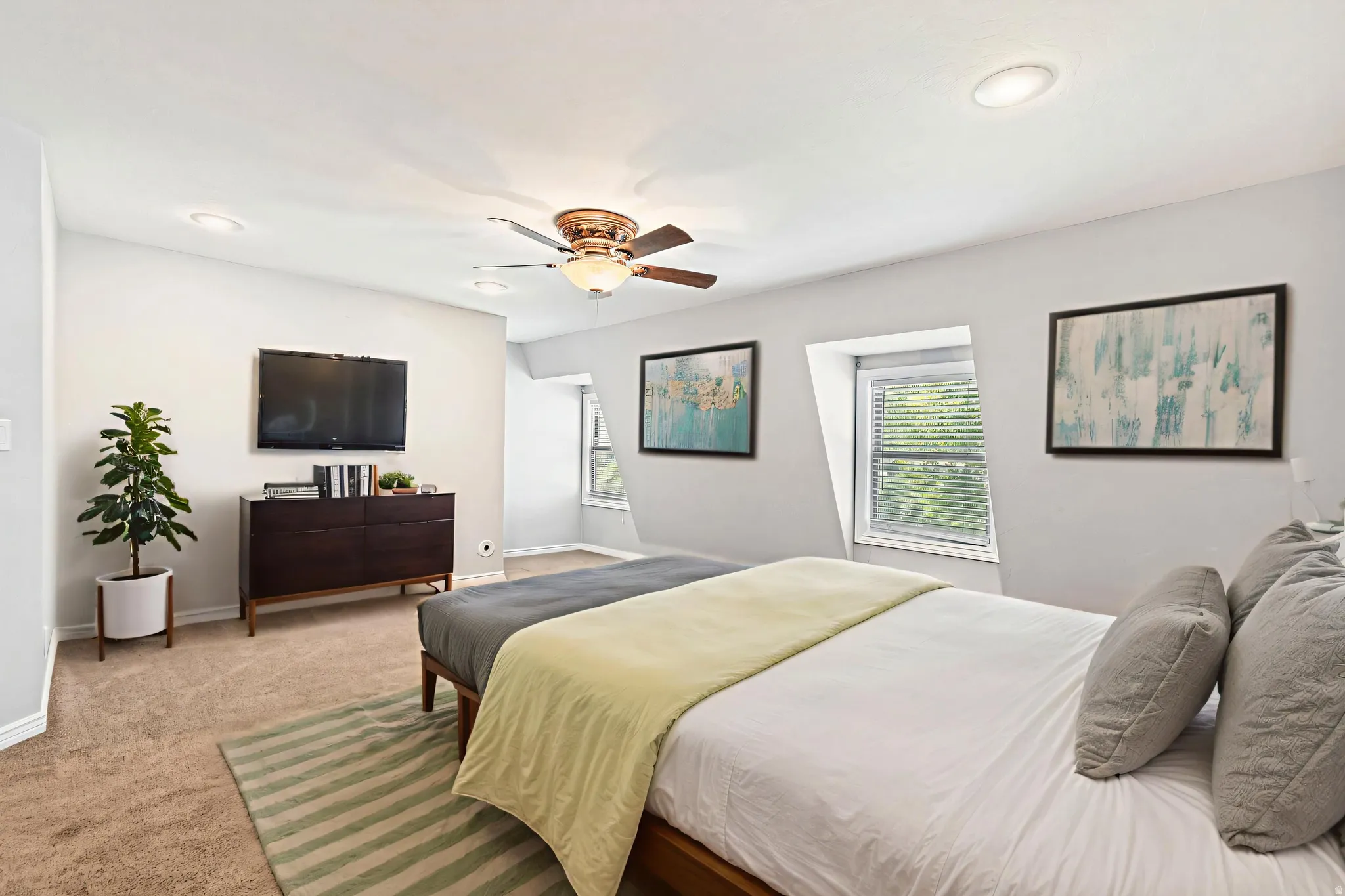 Virtually staged primary suite - Carpeted room featuring recessed lighting, a ceiling fan, and two windows with blinds