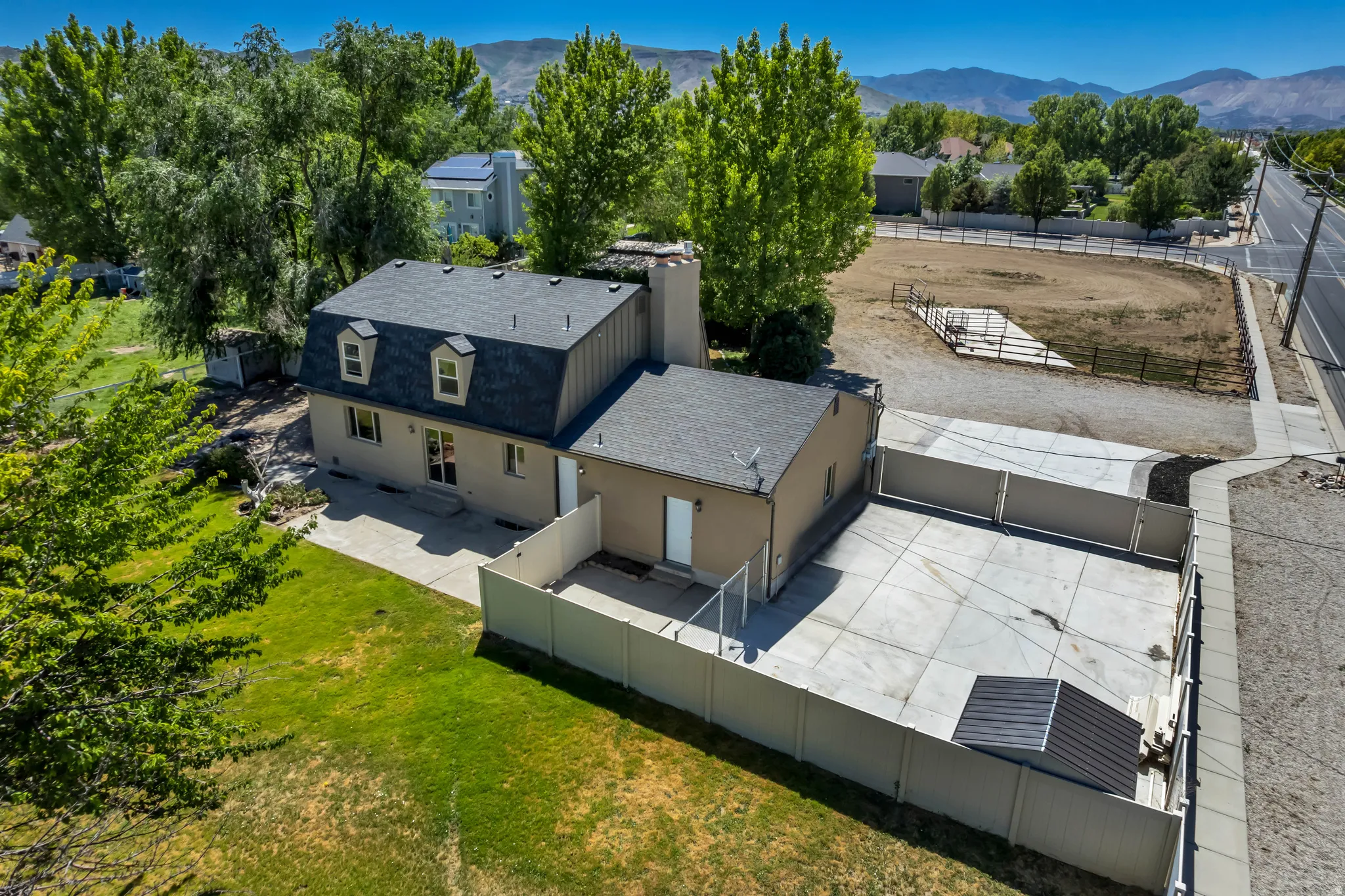 Mansionette-style residence featuring dormer windows and a shingled roof