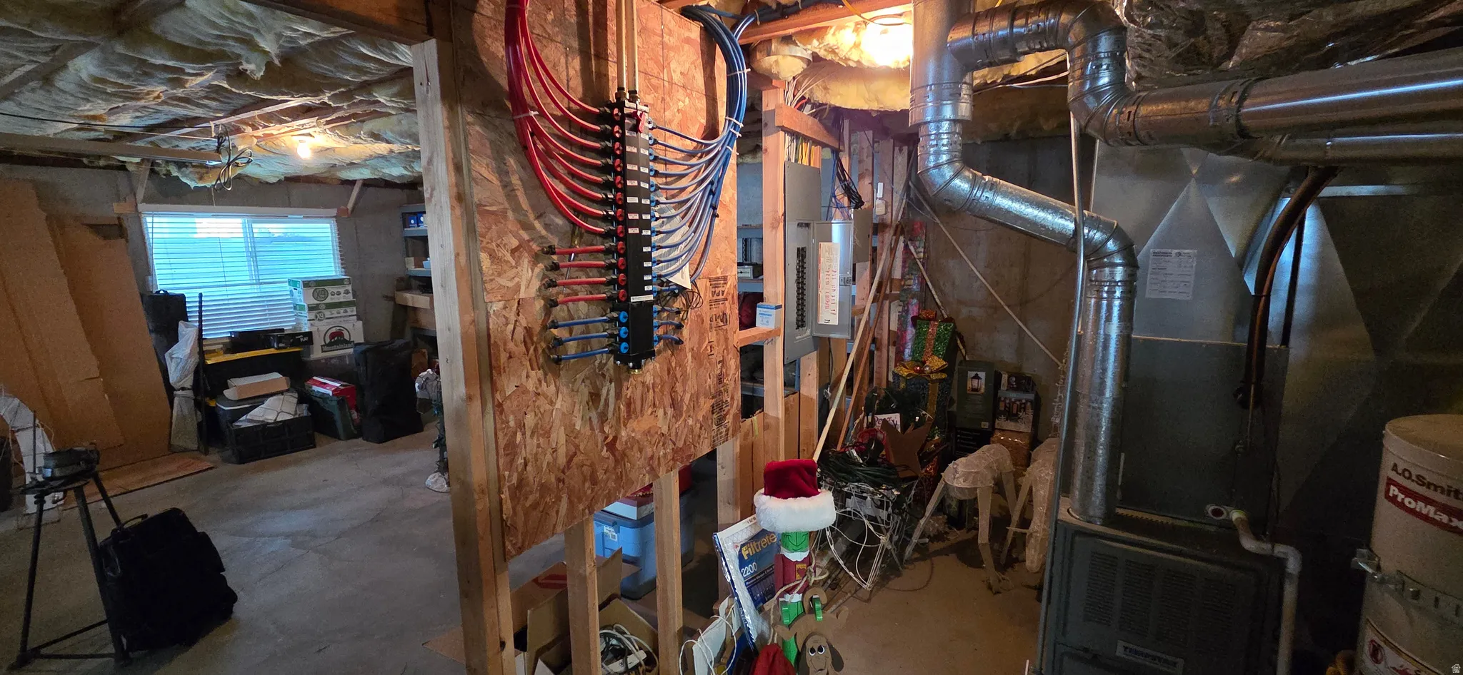 Basement utility area with water distribution and electrical panel