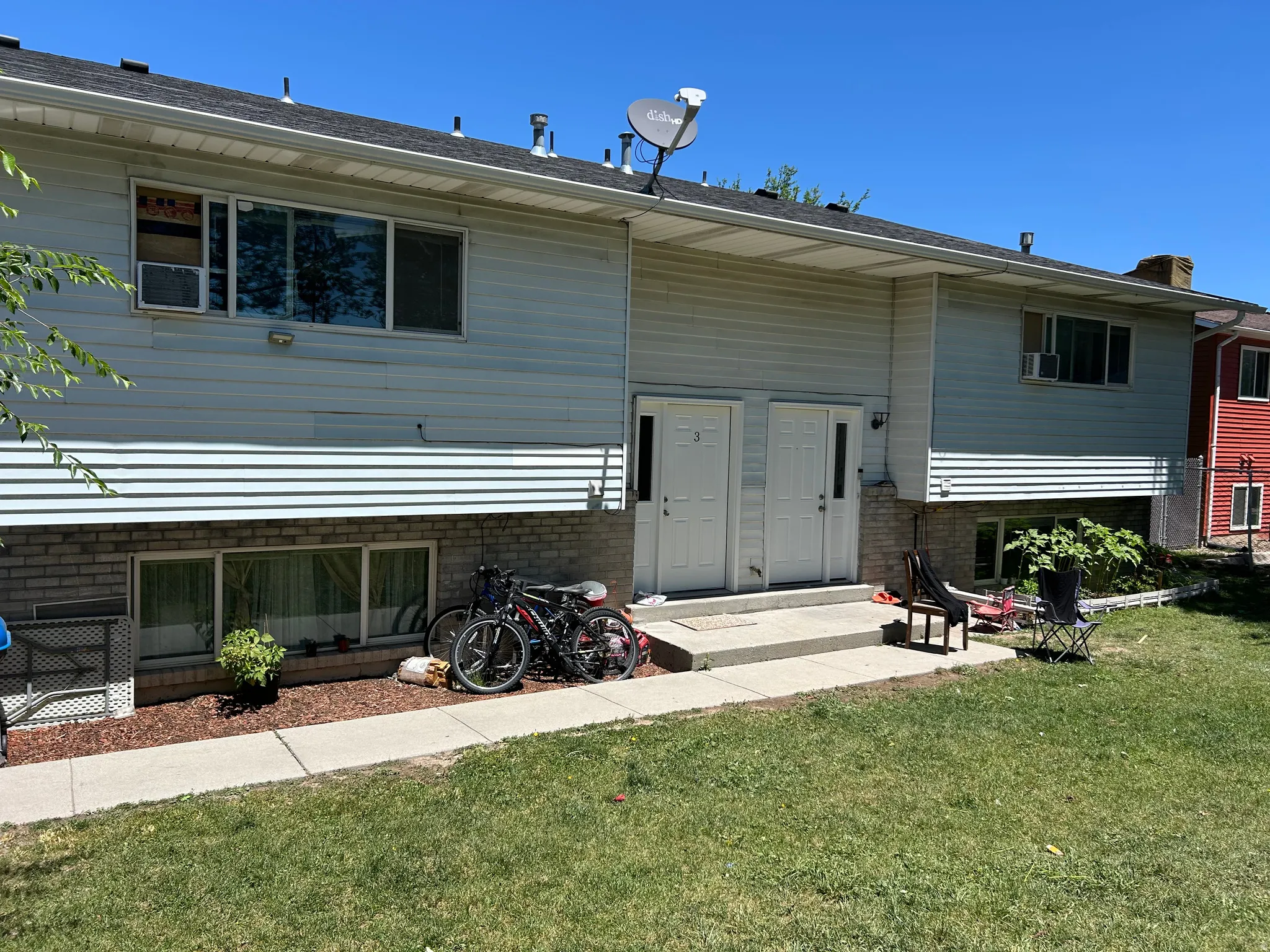 Exterior featuring light blue siding over a brick foundation