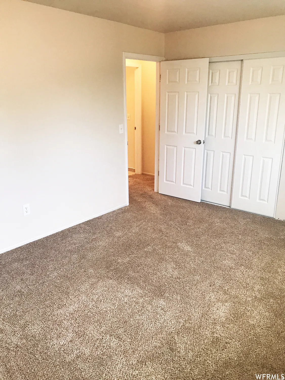 Neutral-toned carpeting paired with light-colored walls