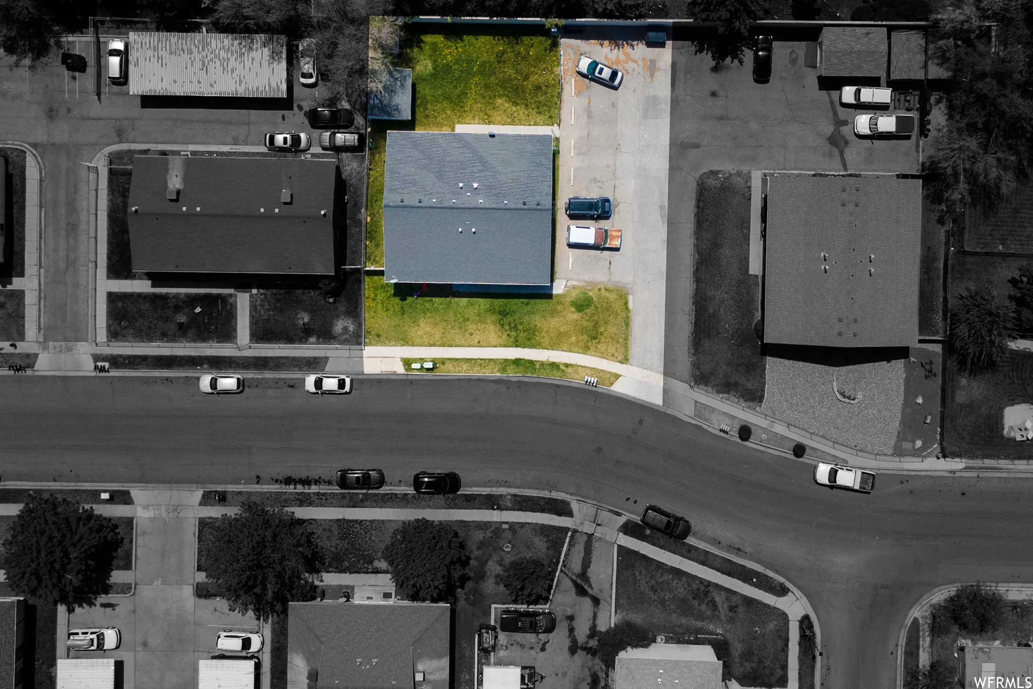 Building with a gray roof and surrounding green space