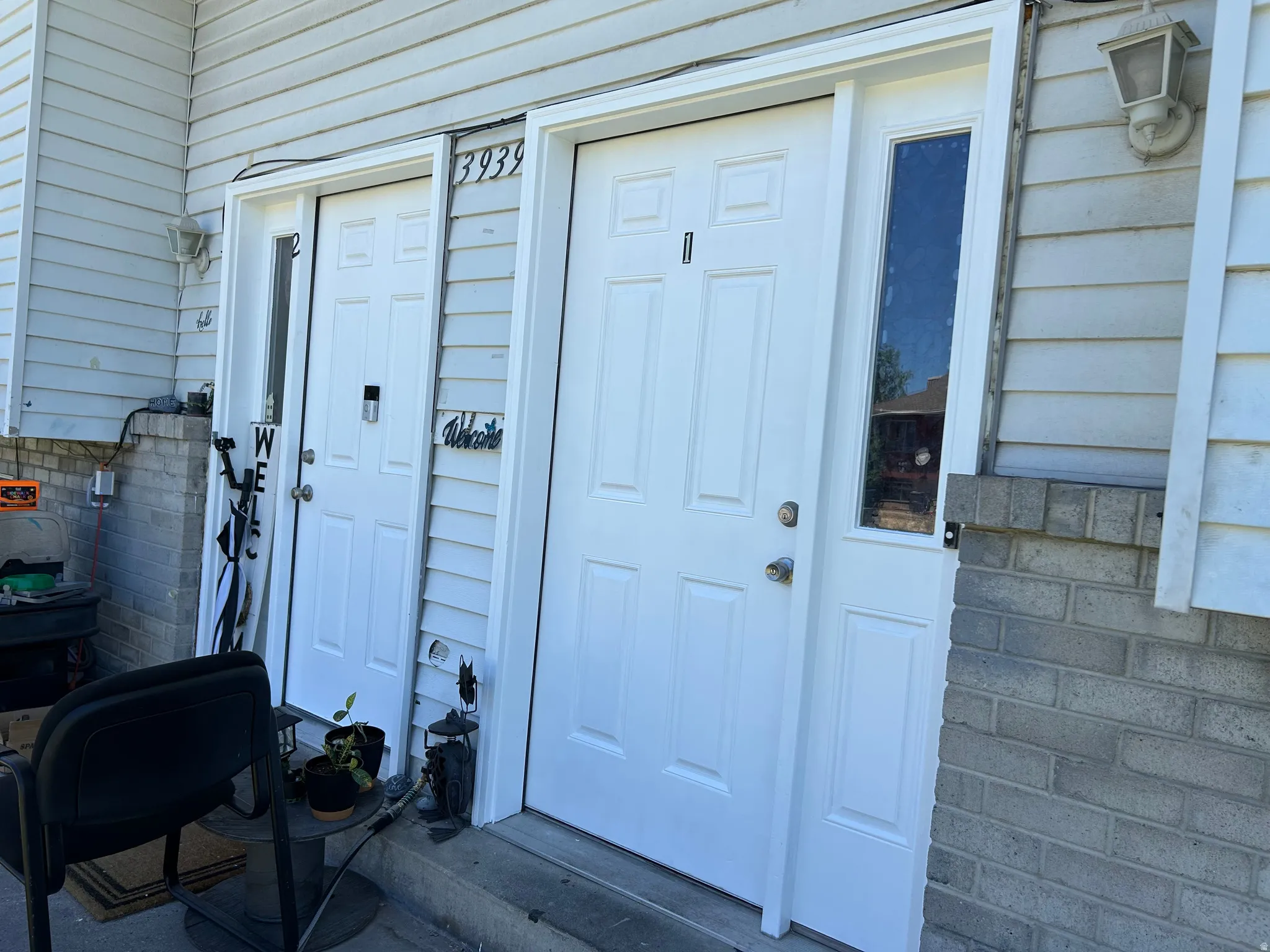 White paneled entrance doors with sidelight windows