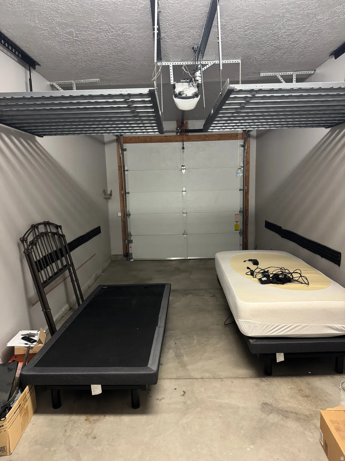 Garage interior featuring a white overhead door and concrete flooring