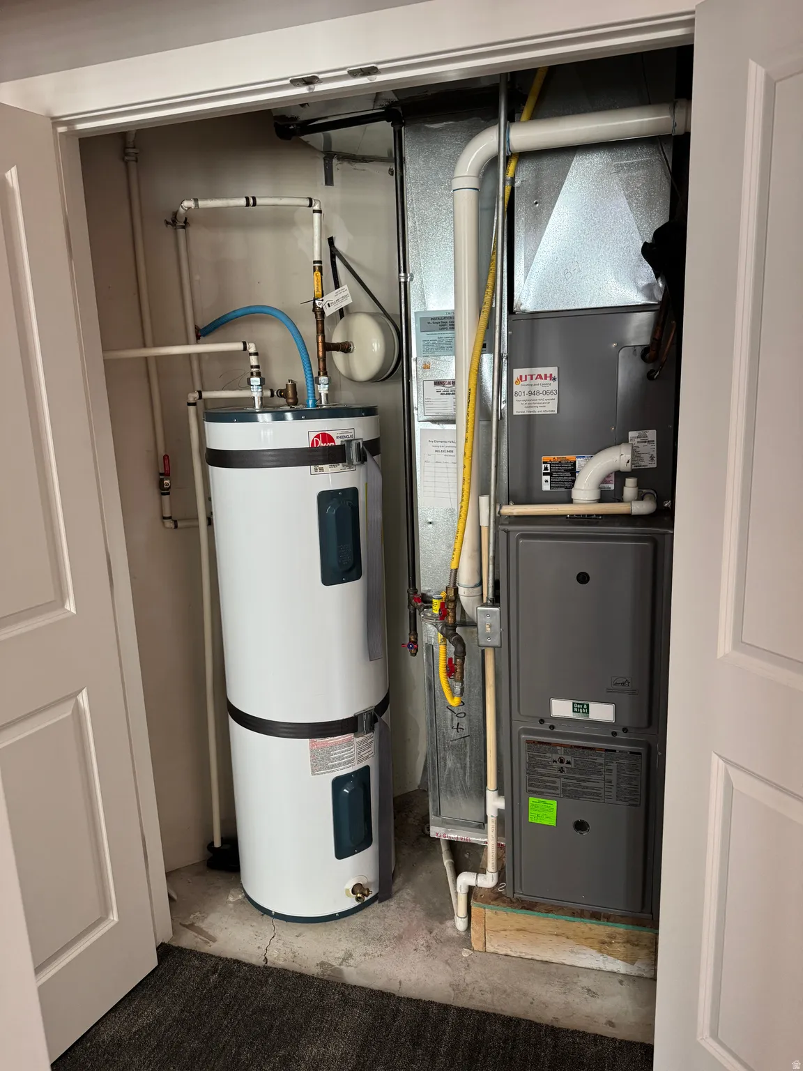 Utility closet housing a water heater and furnace system