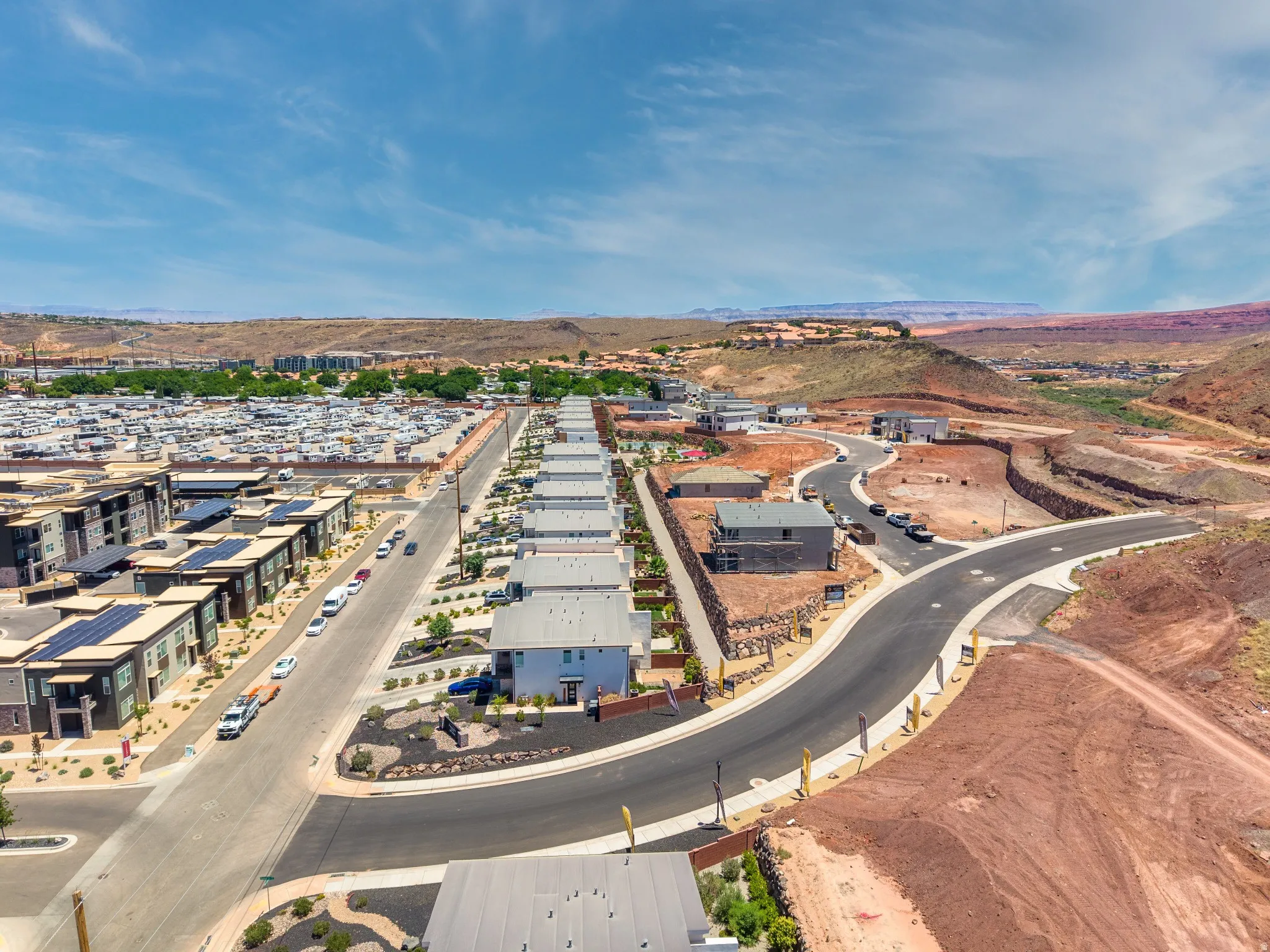Aerial perspective of a developing residential community featuring a paved street network