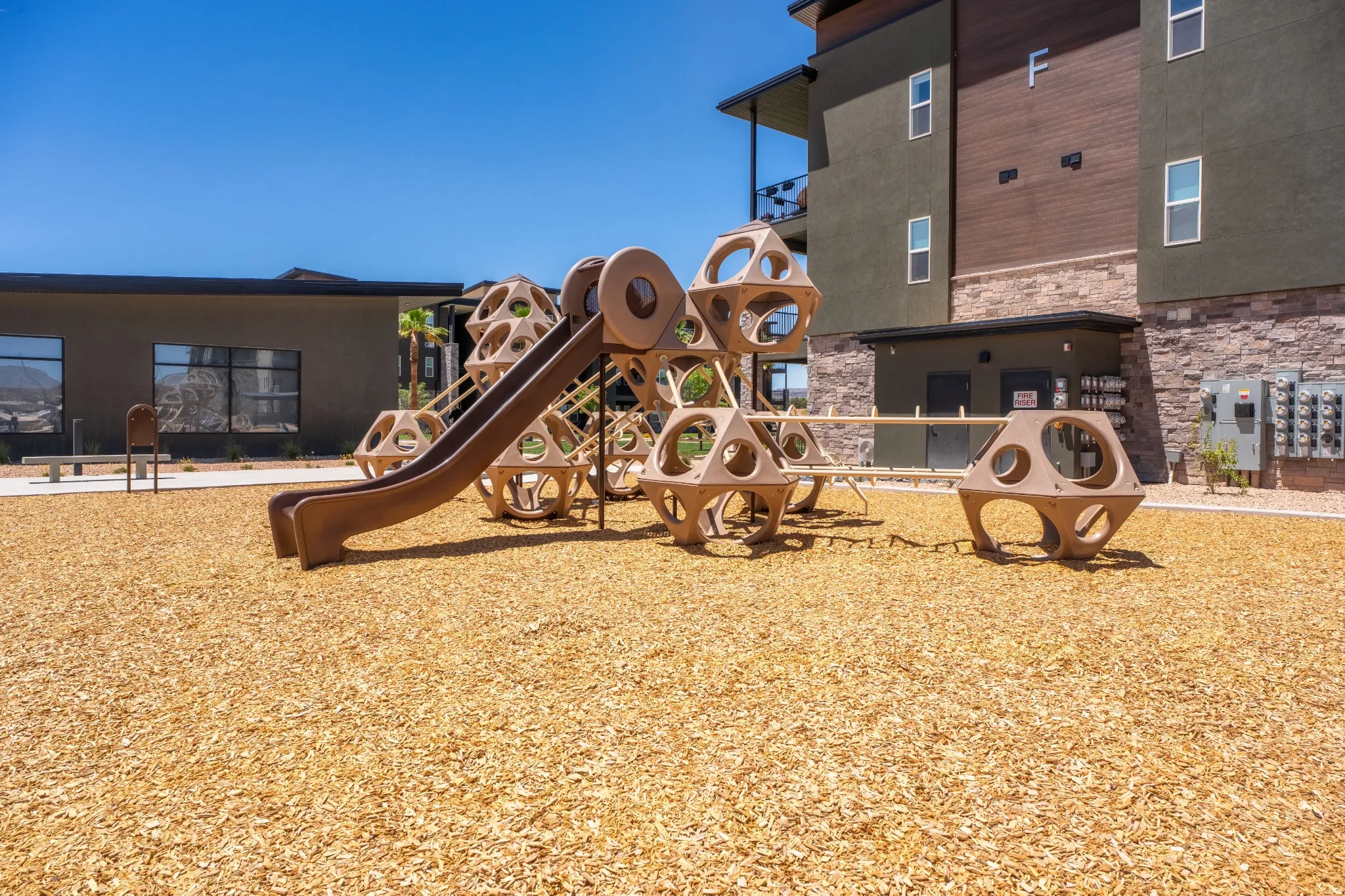 Recreational play structure featuring a slide and climbing components