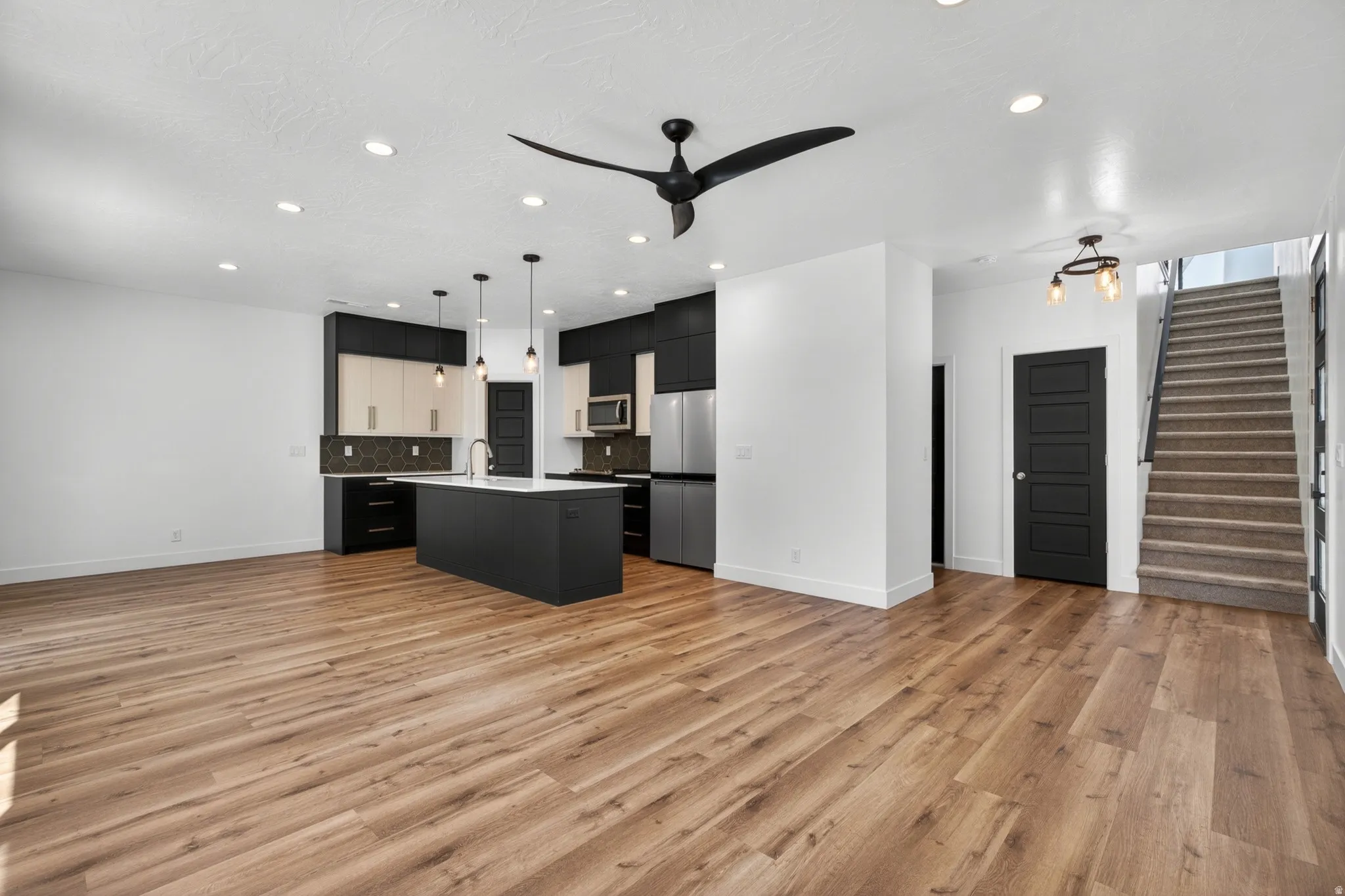 Open-concept living area featuring wood-finish flooring throughout
