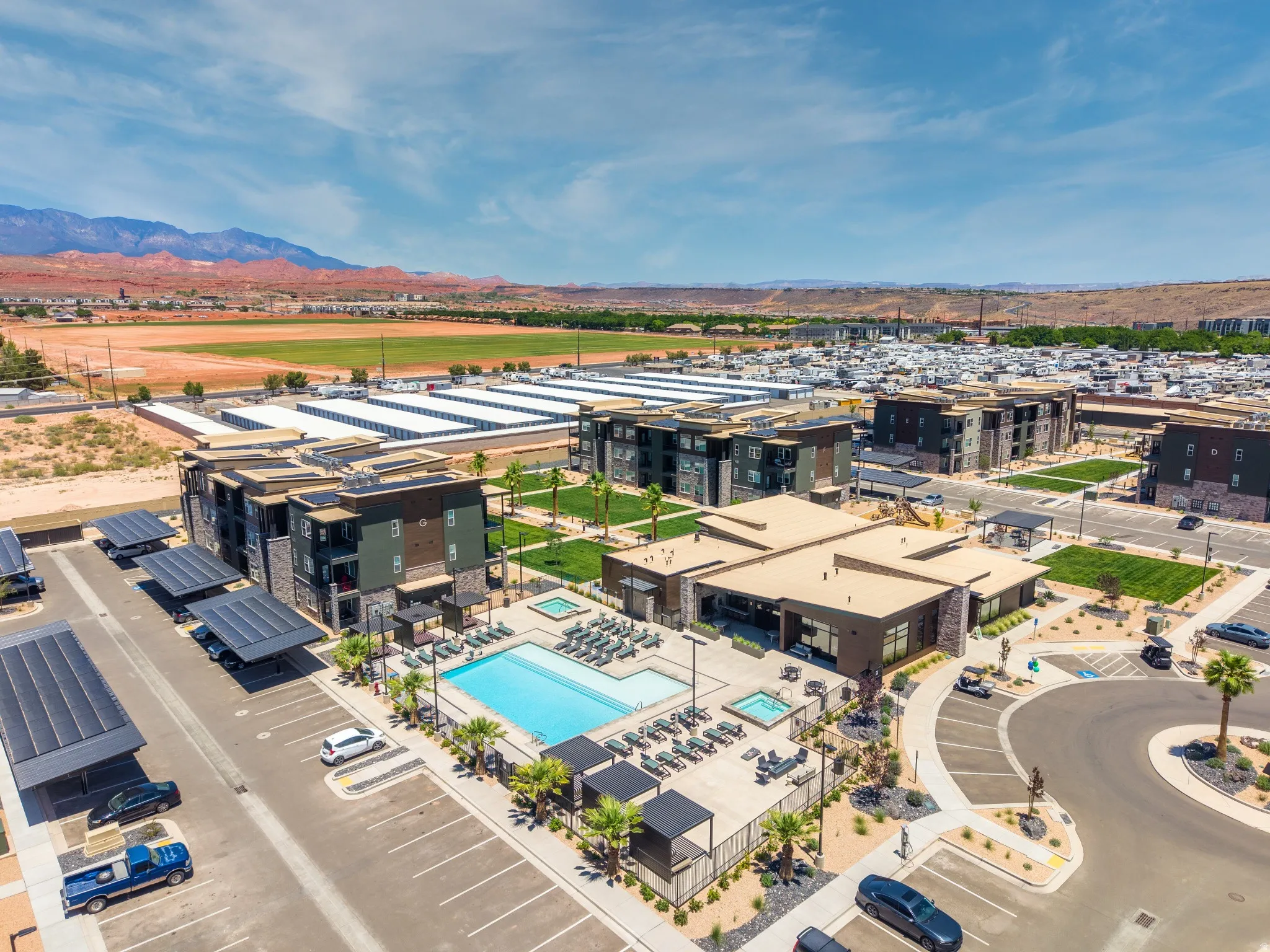 Expansive outdoor pool area featuring a rectangular swimming pool, integrated spa, and multiple lounge chairs