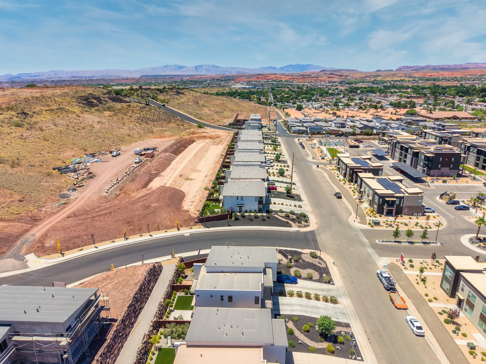 Aerial perspective showcasing a modern residential community with mountain terrain